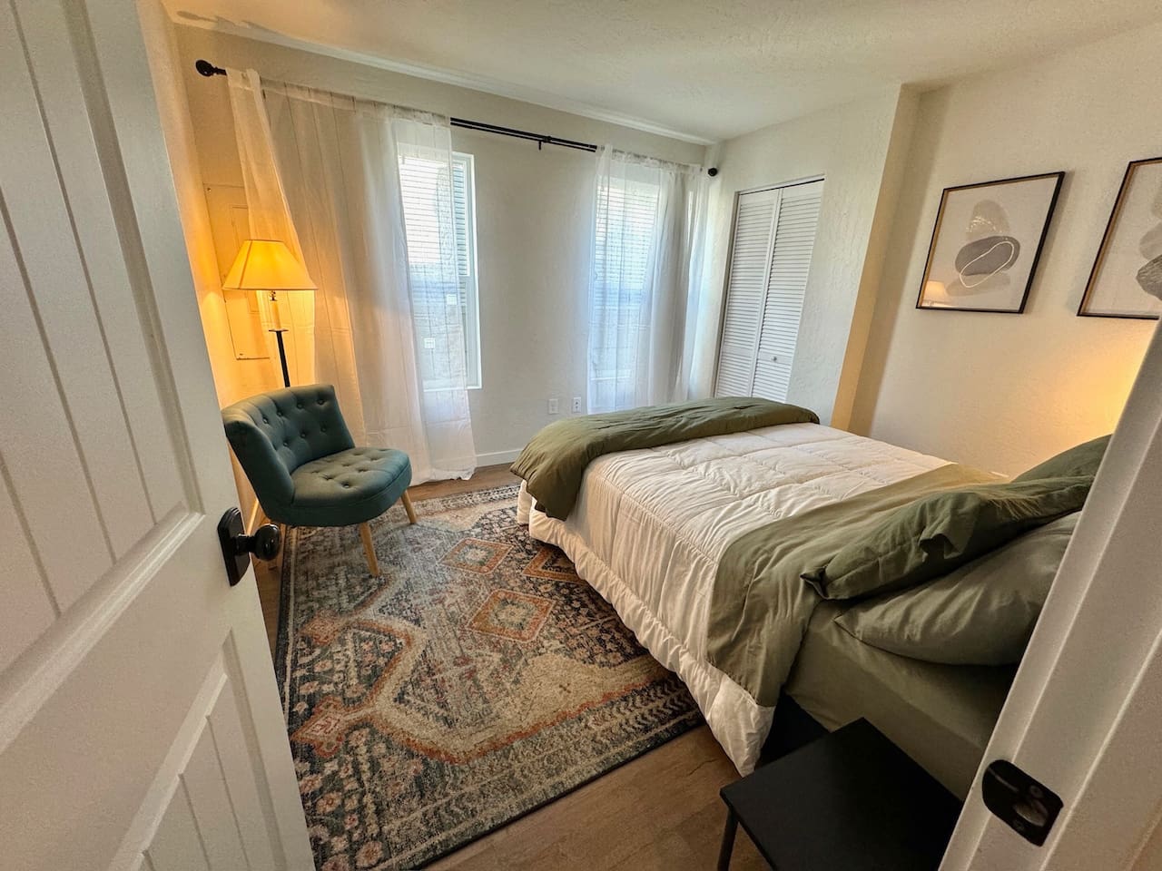 This bedroom features a queen bed, black out curtains, and generous closet space. 