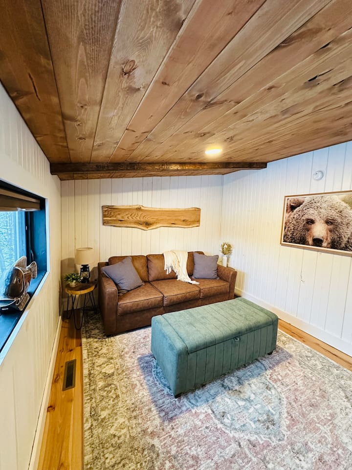 This cozy, open loft features a comfortable queen pullout sofa bed, perfect for two people. The loft overlooks the living room, offering a unique blend of privacy and openness, ideal for those who enjoy a spacious and airy living environment.