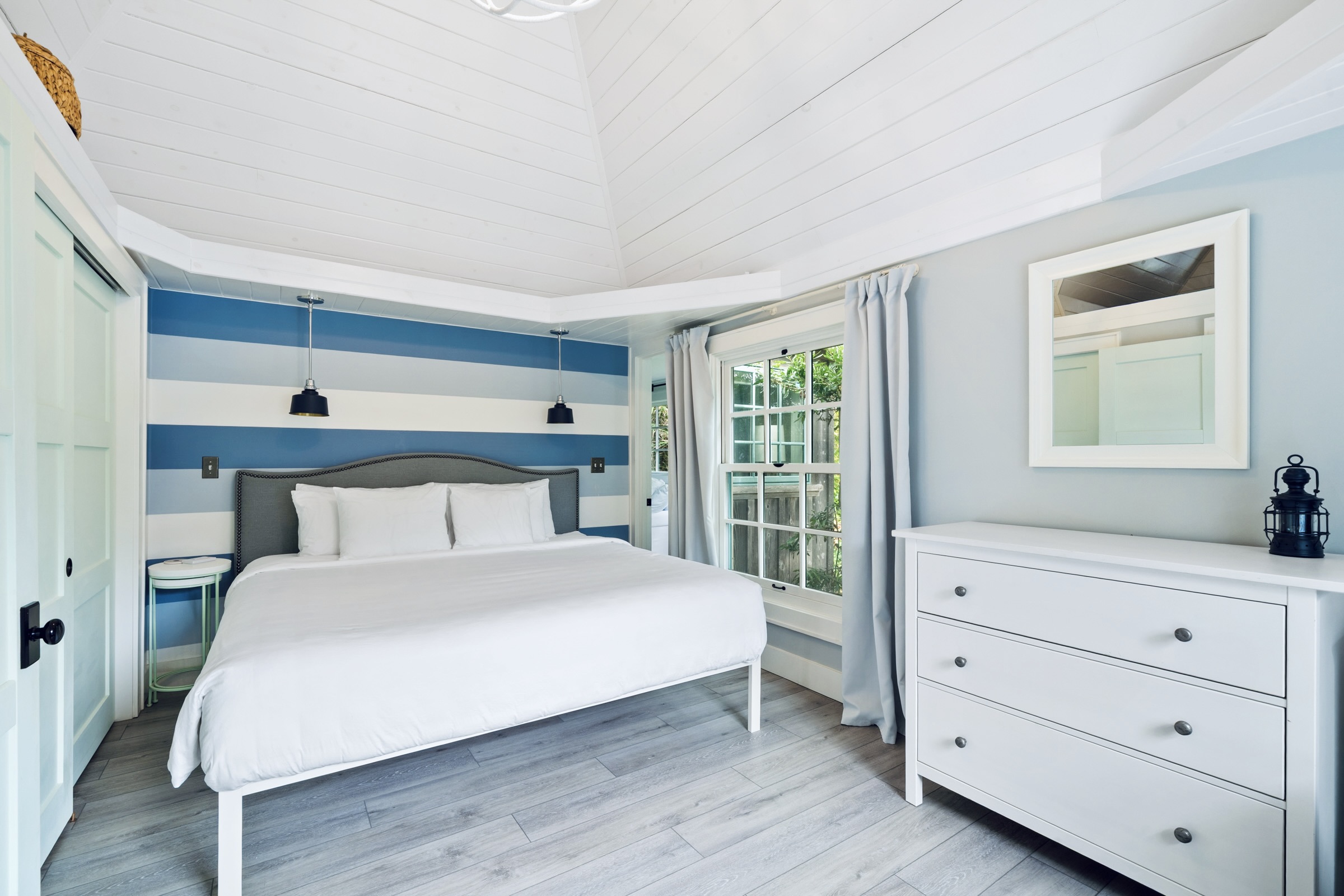 NAUTICAL BEDROOM  corner shows interior access to primary suite through narrow doorway, or there is exterior access - no true hallway