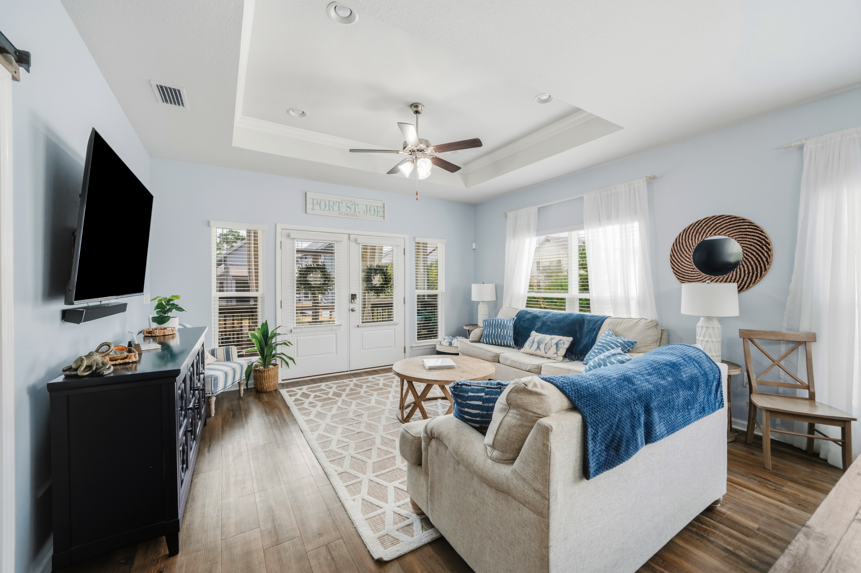 Relax in comfort. Bright and inviting living room with plush seating, perfect for movie nights or gathering with family and friends