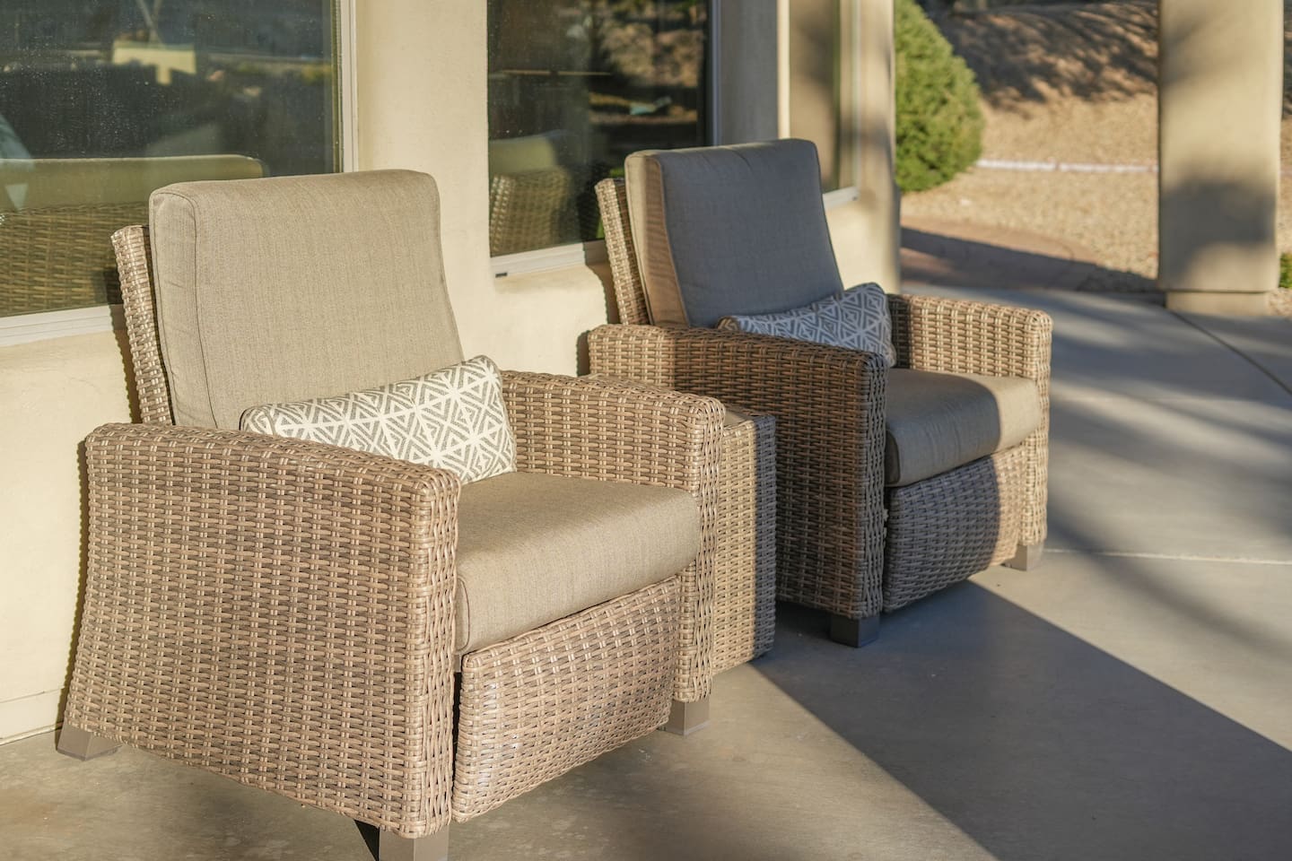 Cozy covered patio seating with cushioned wicker chairs—perfect for morning coffee or relaxing in the shade.