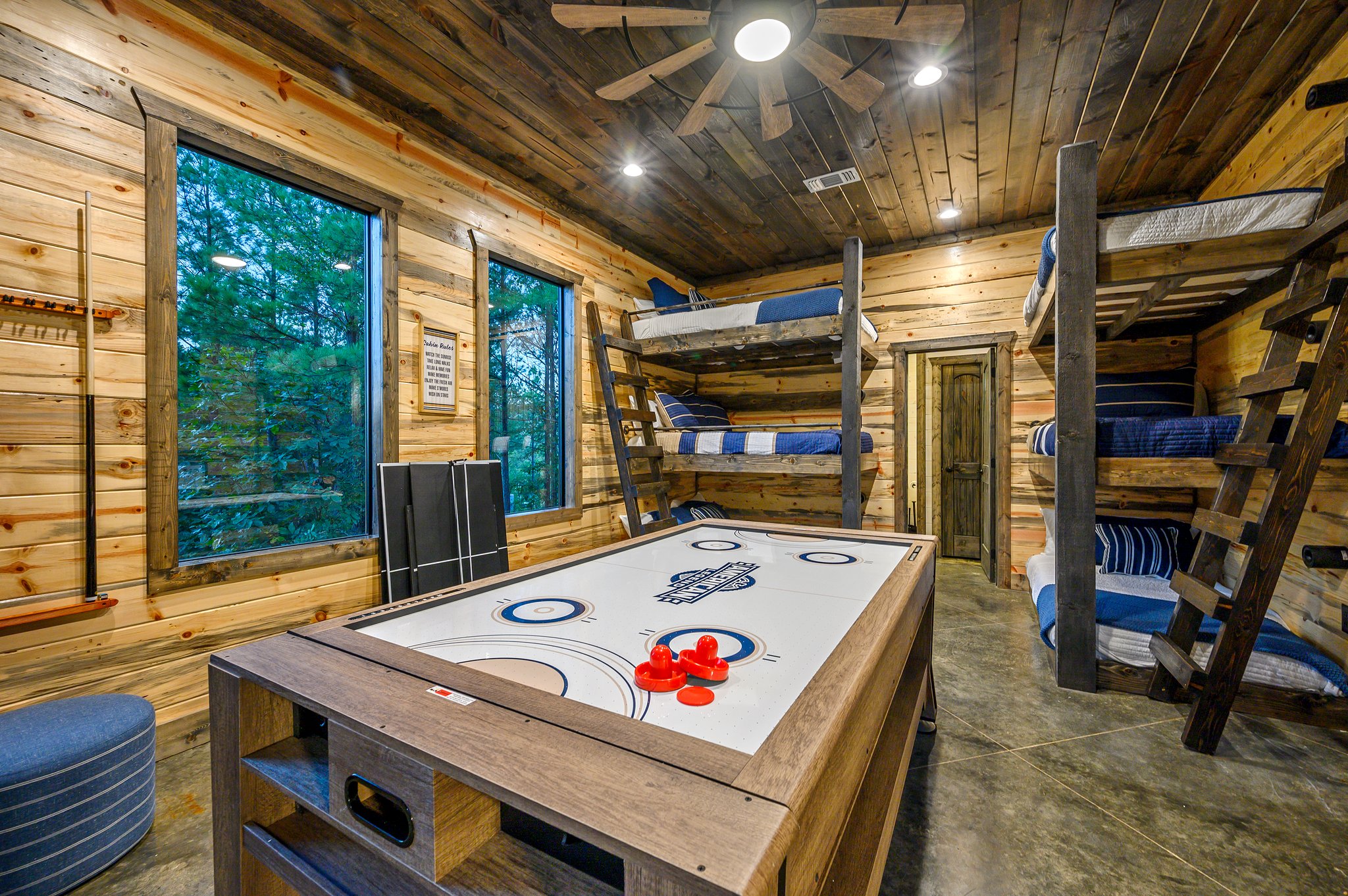 Luxury wood-clad retreat with built-in bunks and ultimate game-night vibes.