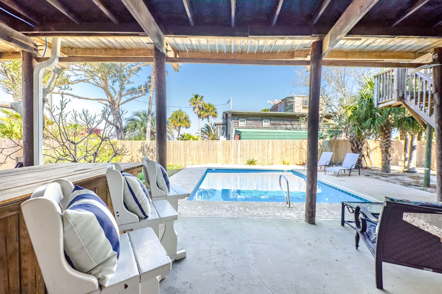 Outdoor Lounge: Relax by the pool with a drink in hand and soak up the Gulf Shores sun!
