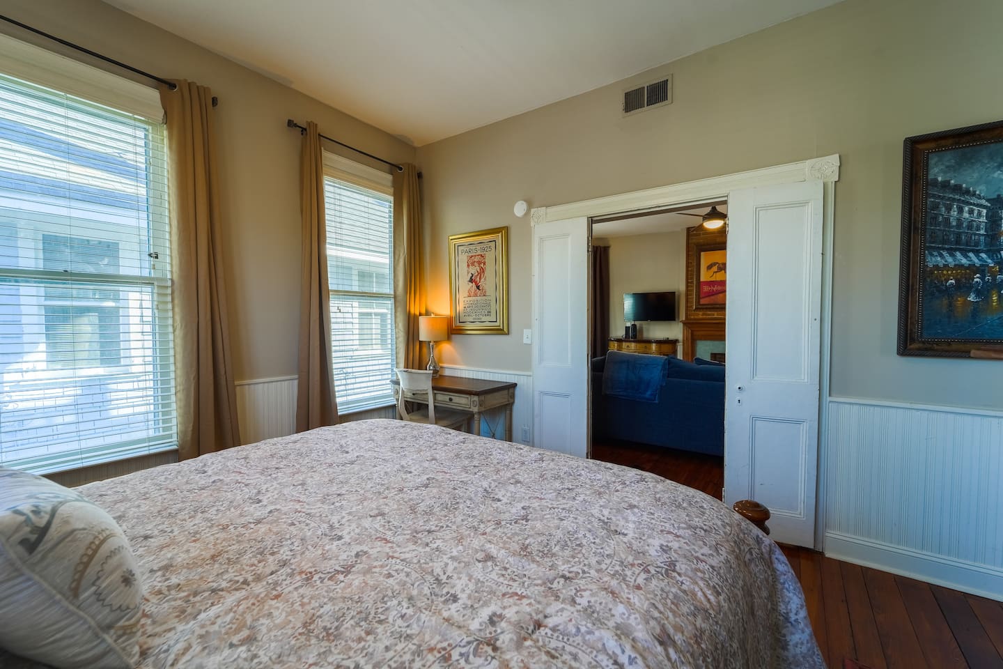 The primary bedroom is conveniently located off of the living room with bi-fold doors for privacy. Offers a well-lit desk area.