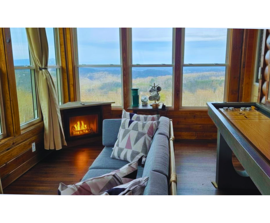 Enclosed deck featuring mountain views, seating area with electric fireplace (newly added!), coffee station and shuffleboard