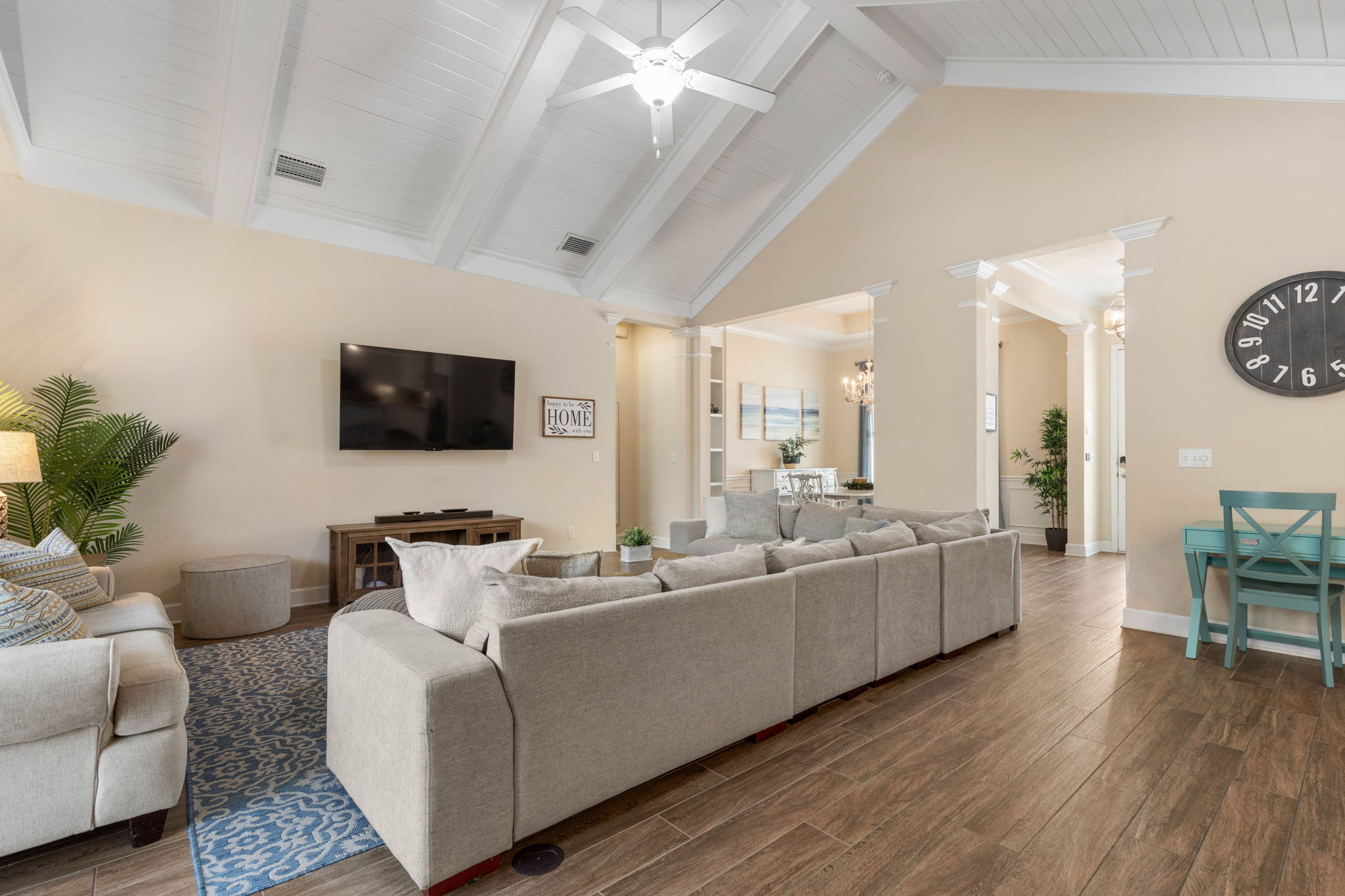 Kick off your sandals, sink into the oversized sectional, and let the evening settle in—movie on, snacks nearby, beach stories still fresh, and plenty of room for everyone to relax together under the soaring ceiling.
