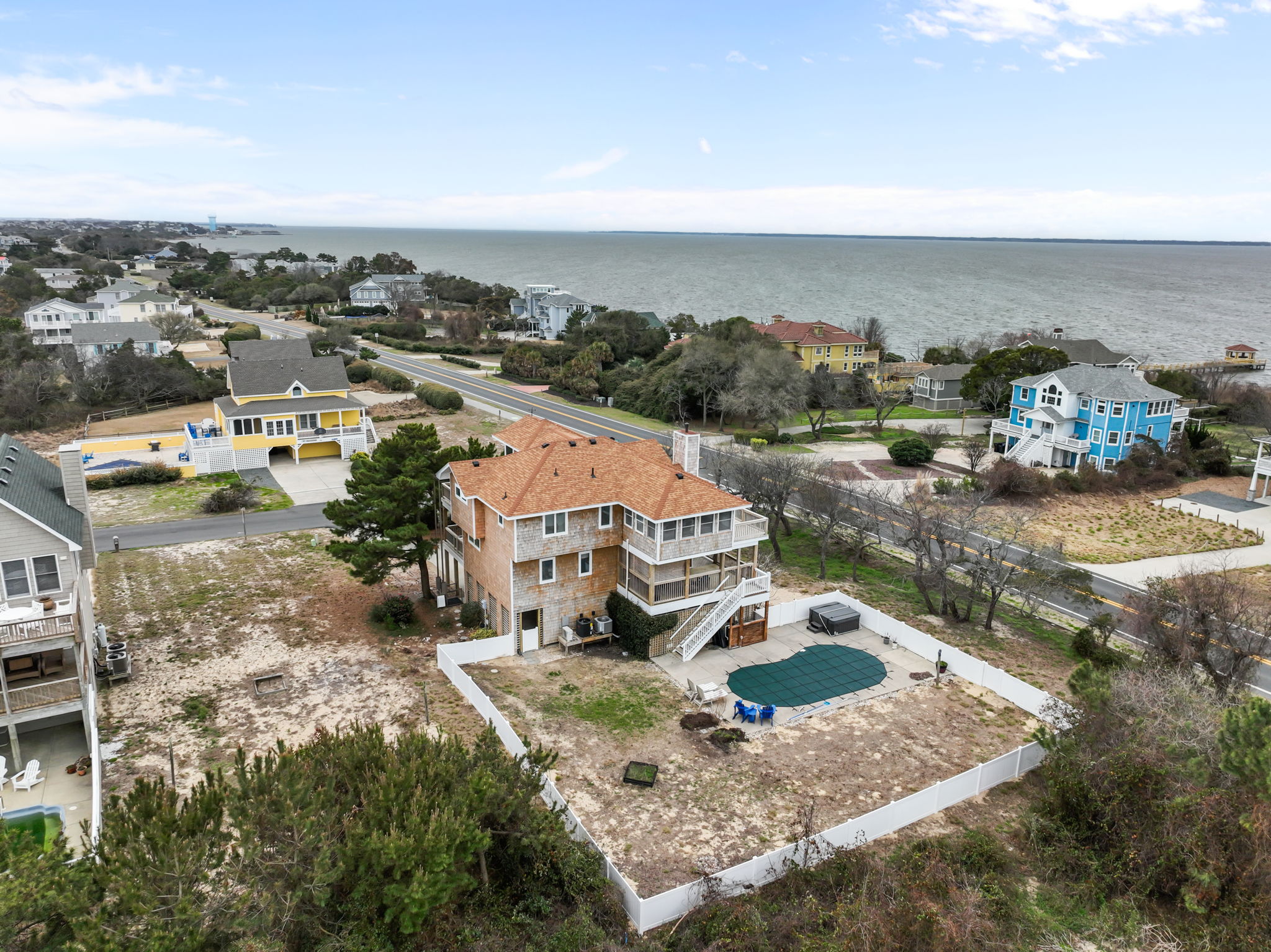 Aerial of the home with private pool and open yard space, great for relaxing outside.