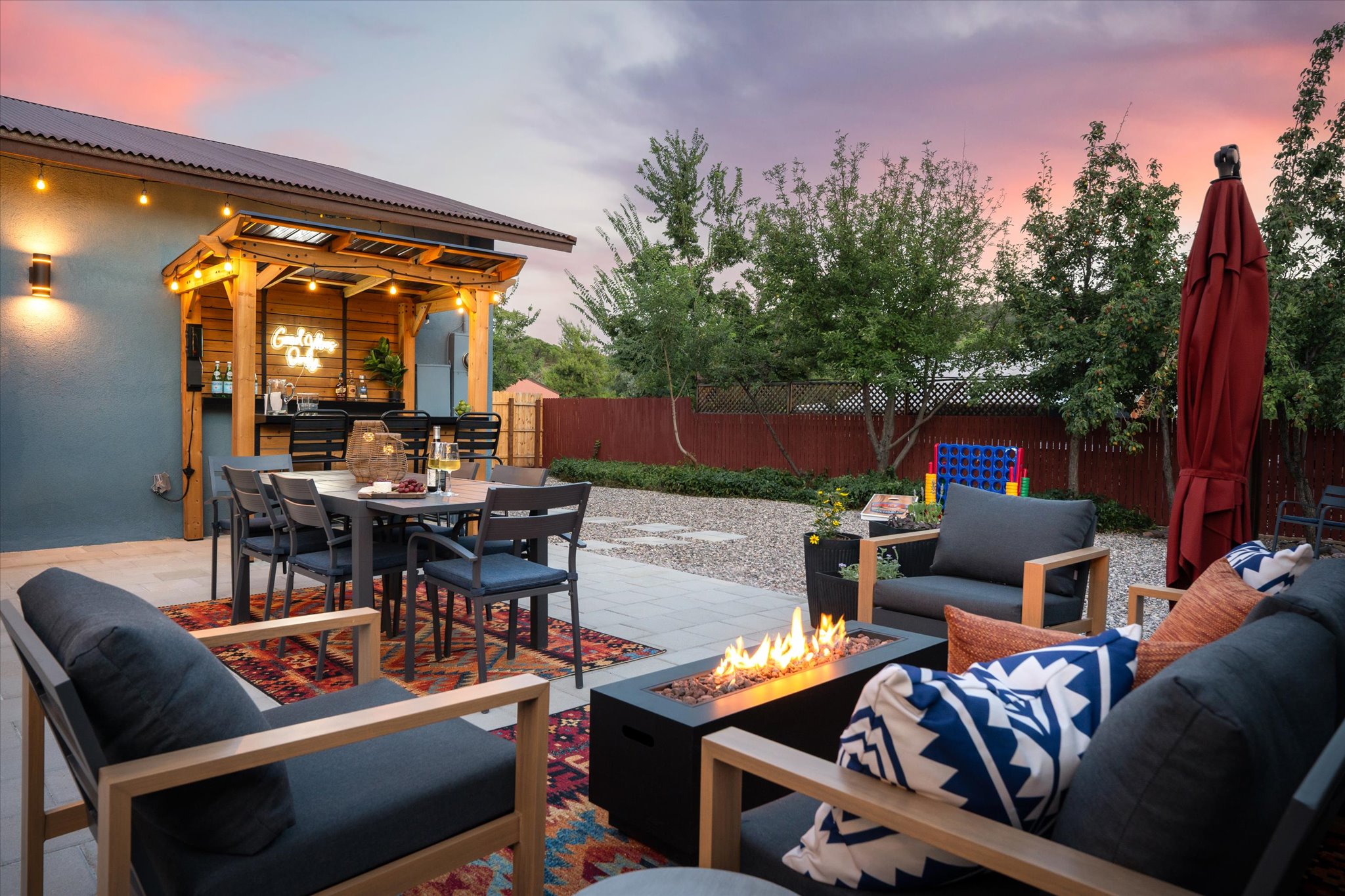 As the sun sets, this backyard oasis transforms into the ultimate gathering spot for good times and relaxation.