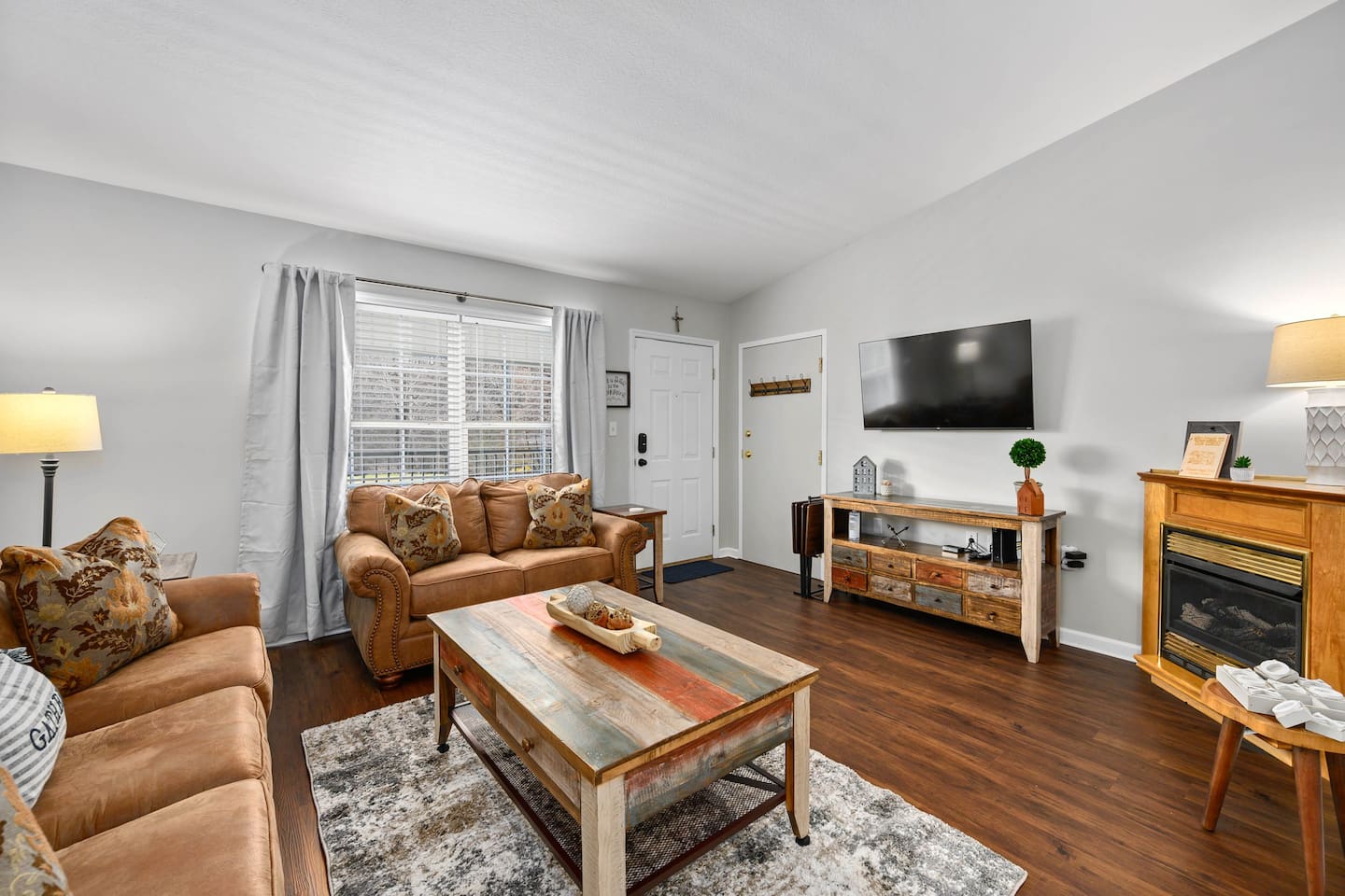Fantastic living area with gas fireplace, flatscreen smart TV, a sleeper sofa, and tv trays. 