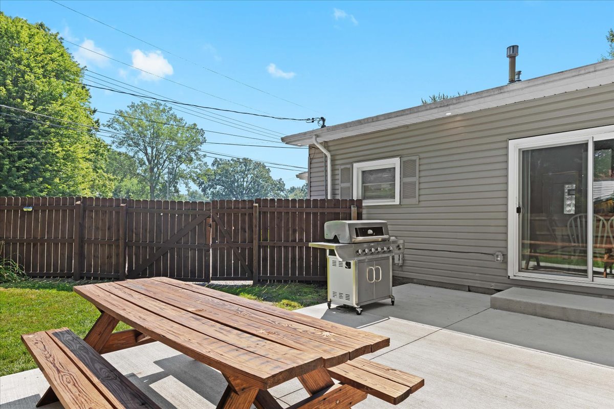 Backyard patio with grill and outdoor dining table
