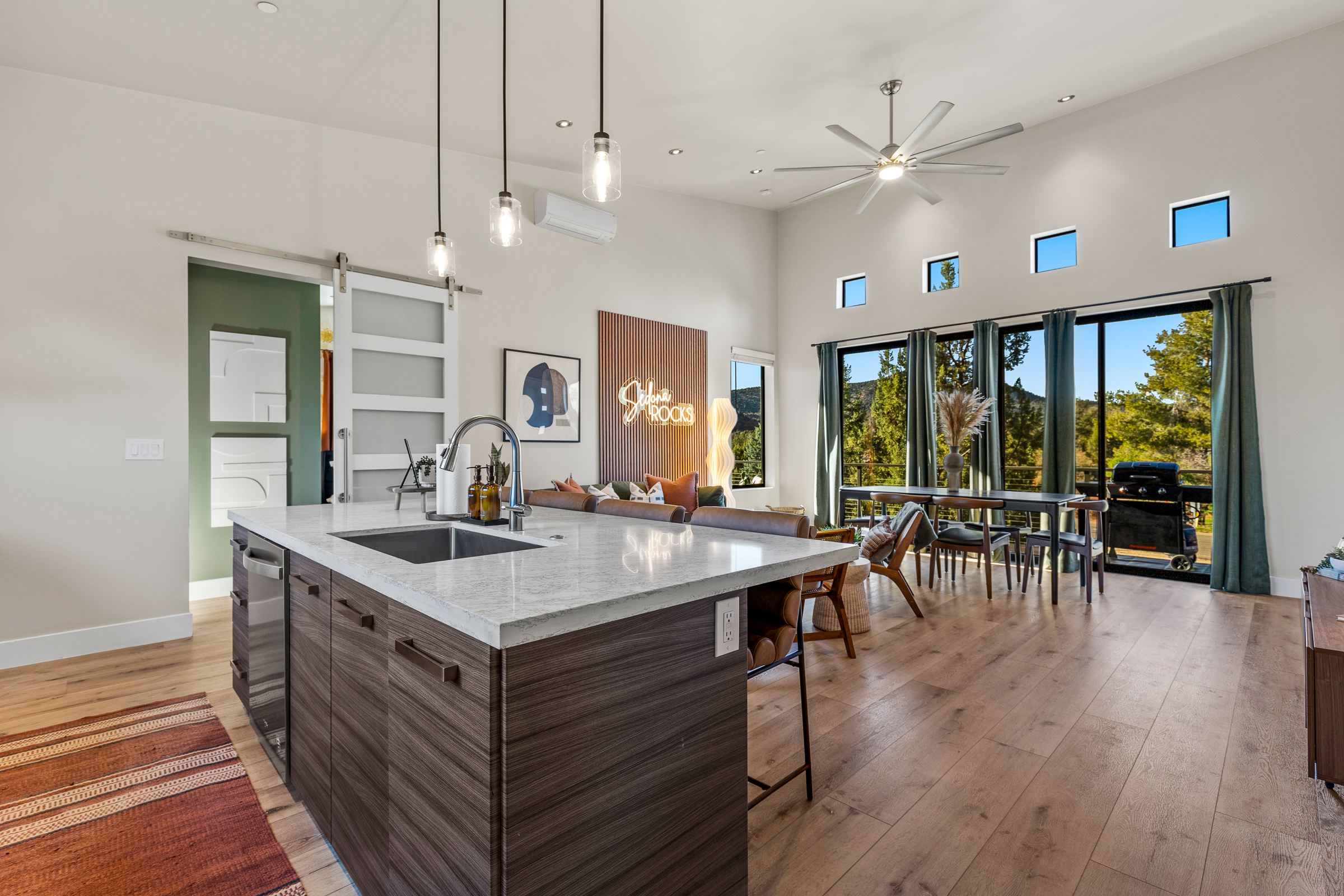 Bright, open spaces connect the kitchen, dining, and living areas, creating a comfortable setting for shared meals and laid-back evenings.