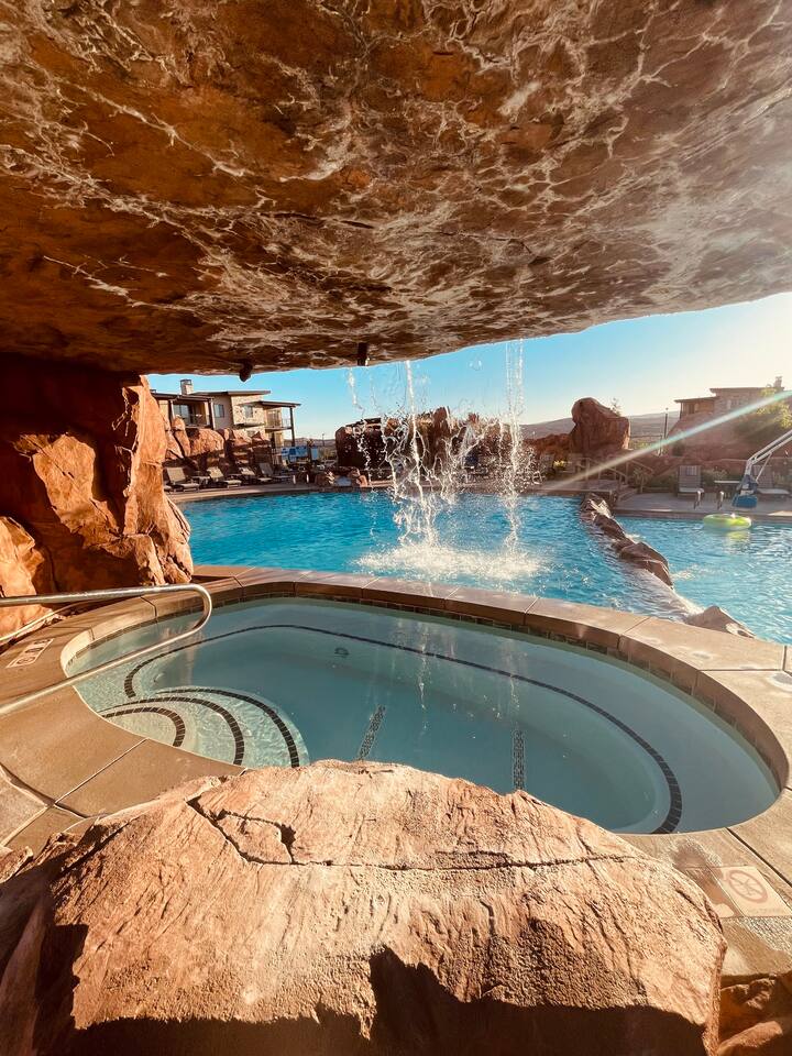Hidden grotto hot tub with pool views