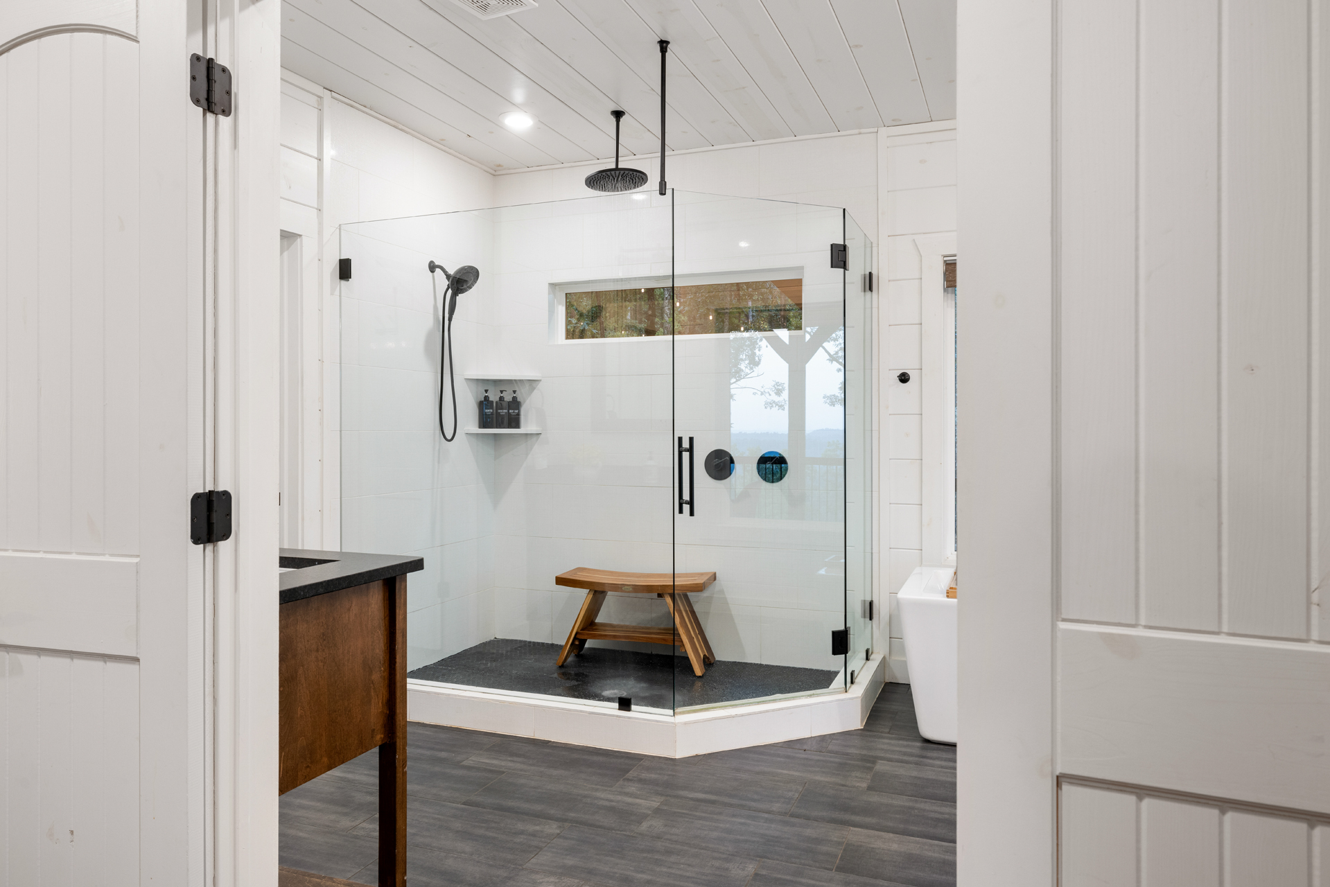 Modern spa-style bathroom with glass shower and elegant clean finishes