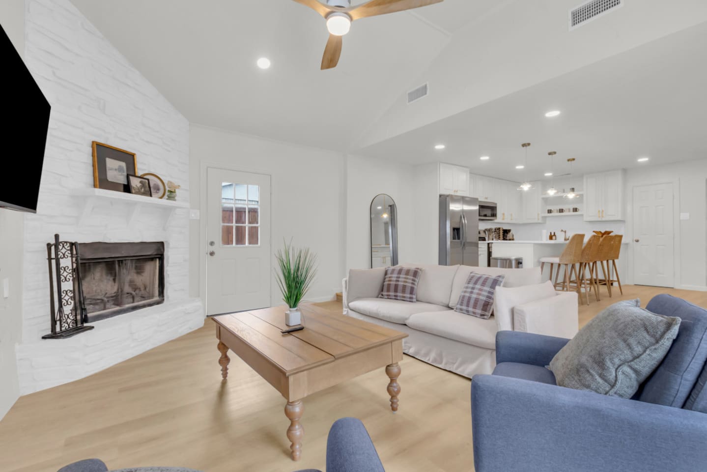 Open-concept layout connects the private living room to the fully stocked kitchen, ideal for group gatherings and long-term stays.