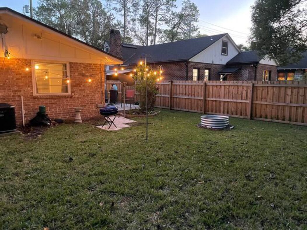 Backyard area with lights that come on at night.
