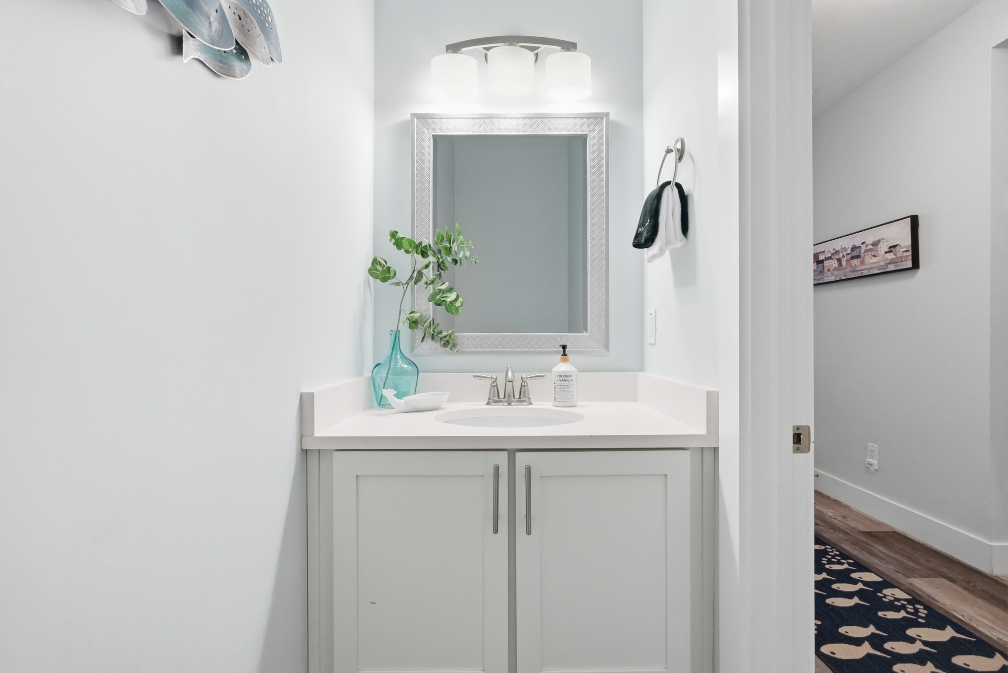 Powder room bathroom situated off the main entry foyer, adjacent to the main living for easy access.