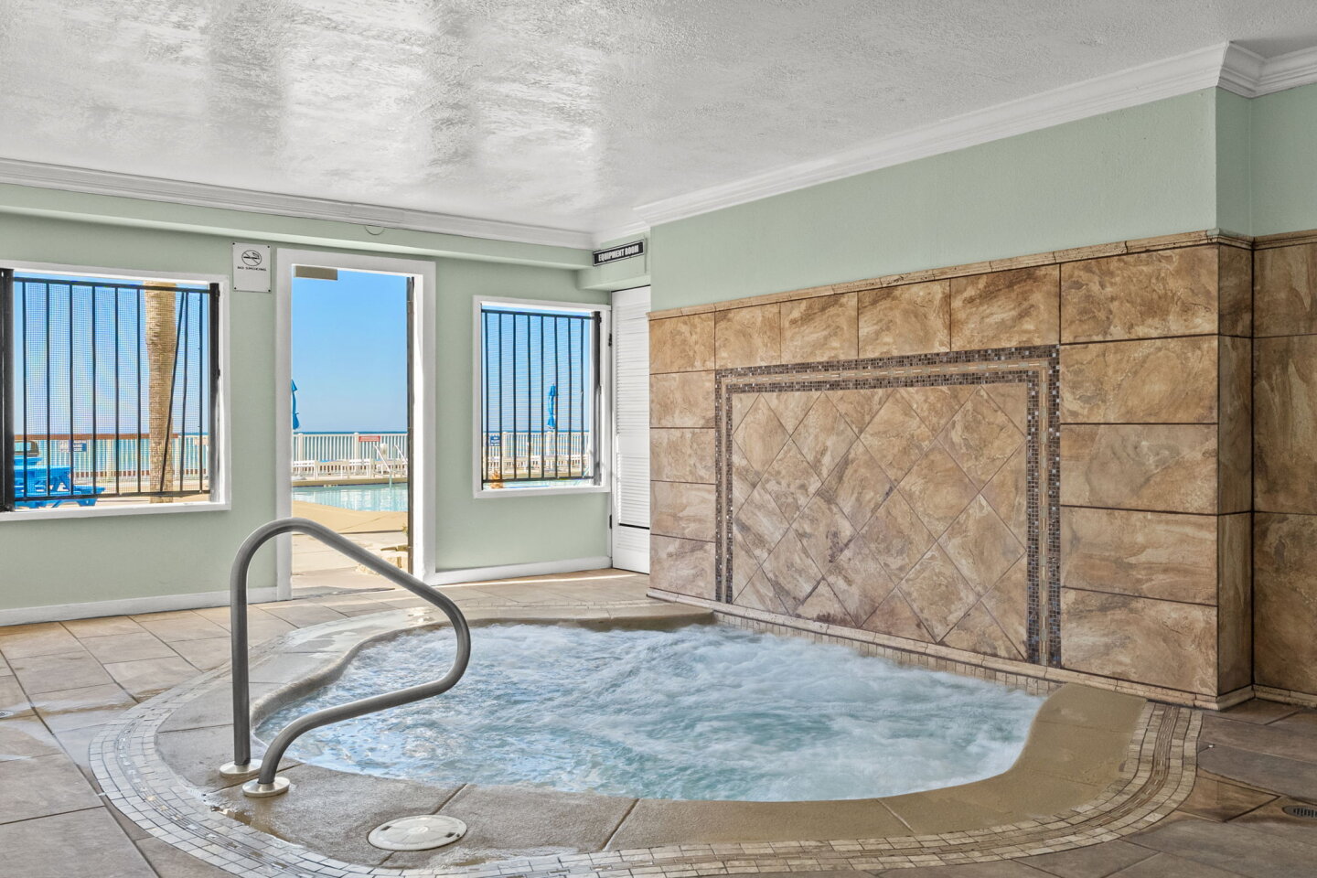 This covered jacuzzi protects you from the wind while you soak. It is located right next to the main pool for easy access.