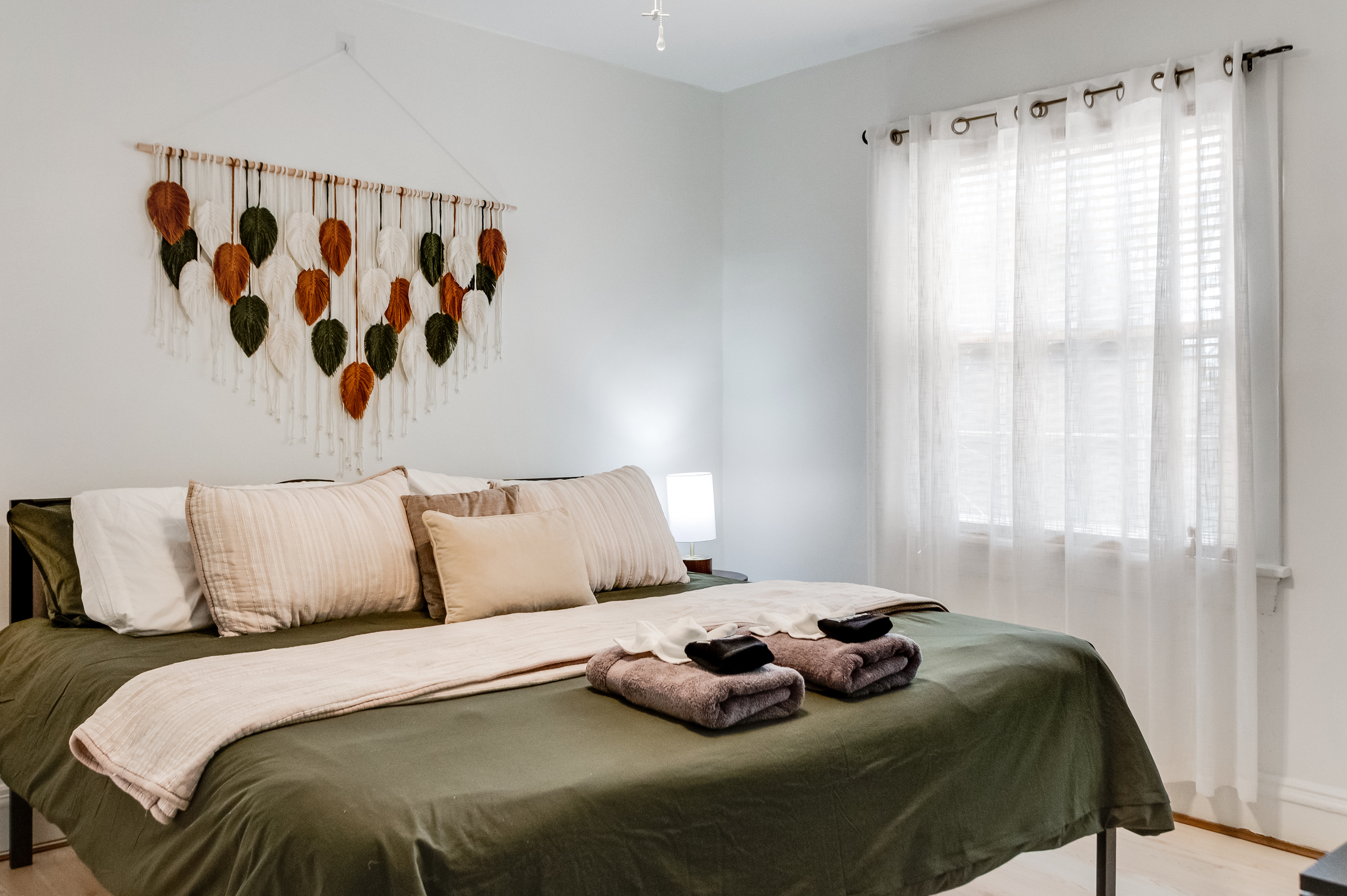 King Bedroom 1: Bright and airy retreat with plush linens and unique leaf-themed decor!