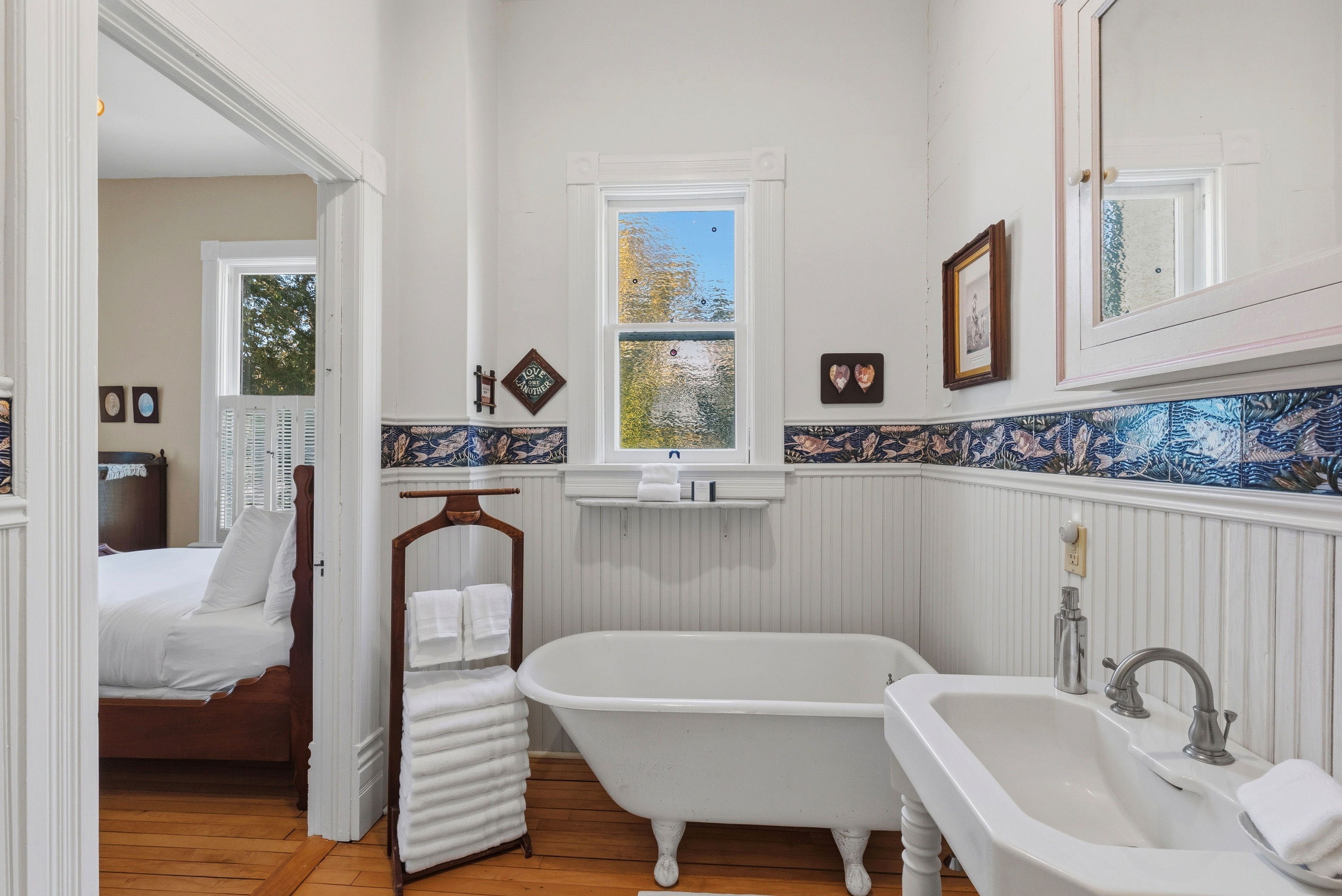 Main floor bathroom w/ tiled walls & clean, simple layout