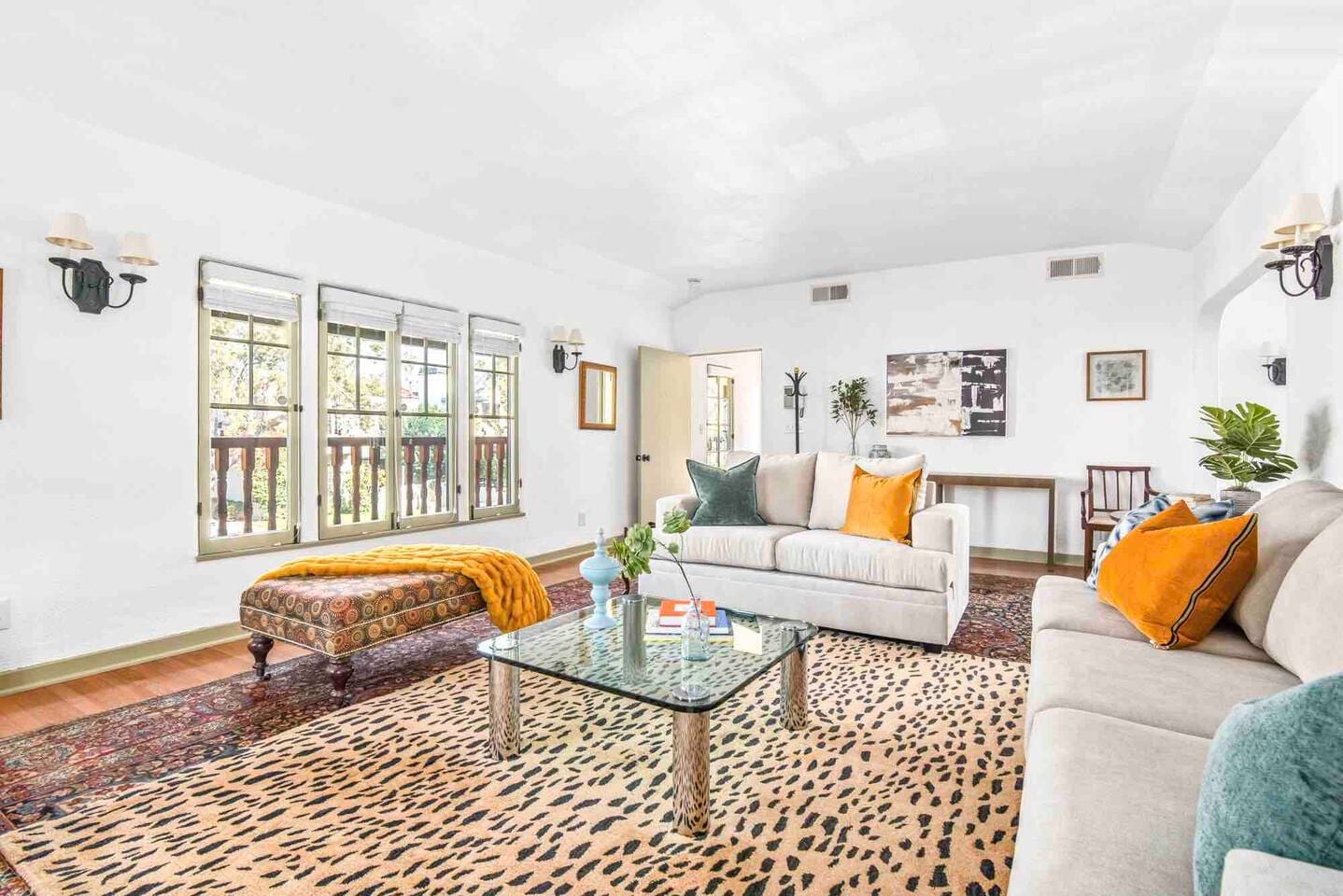 Large windows bring light to this spacious and comfortable living room. 