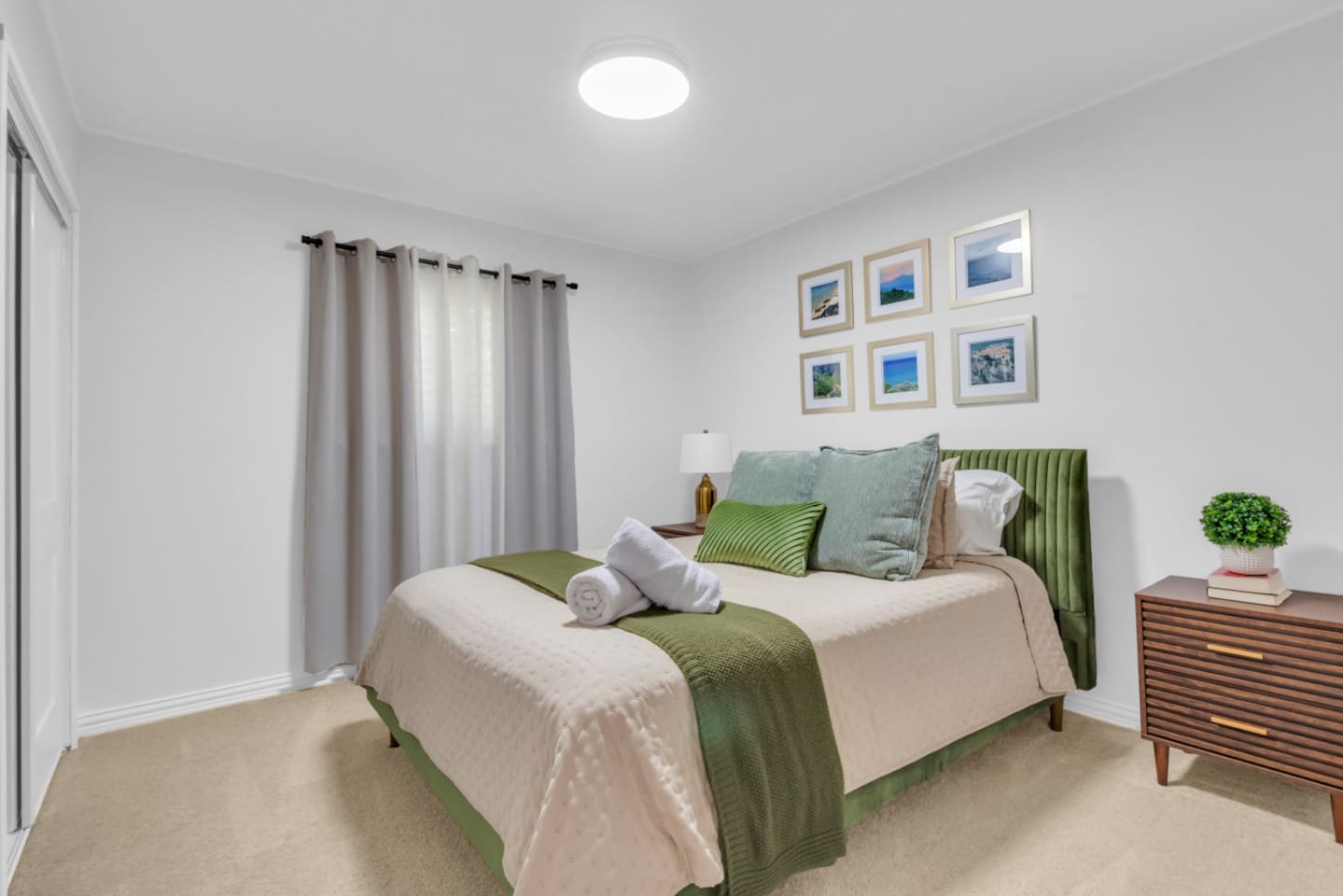 Guets bedroom with a queen bed and black out curtains