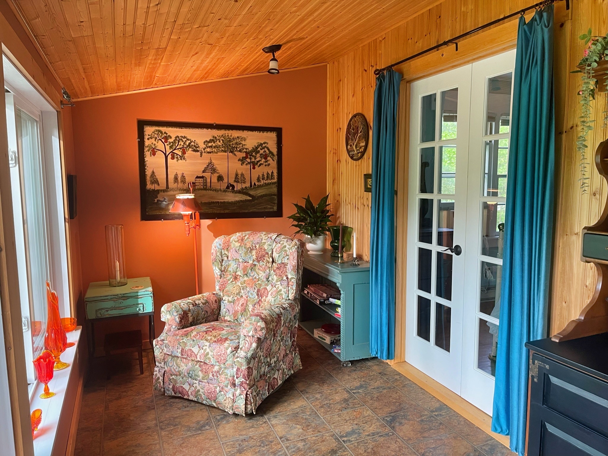 Big Pines sun porch off the queen bedroom is a perfect place to snuggle up with a good book and look at the lake.