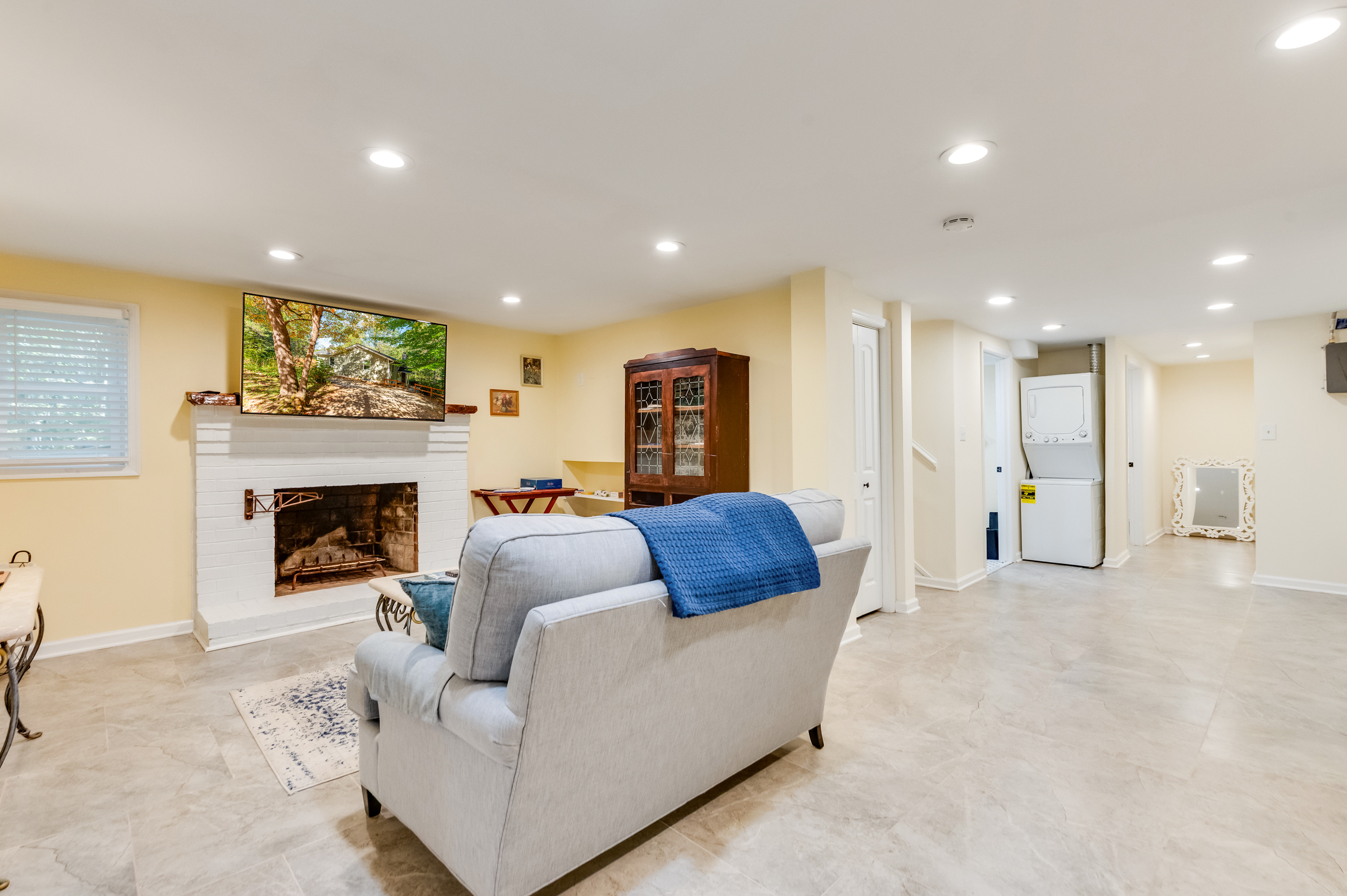 Downstairs Living Room: Bright and inviting space with a fireplace and modern entertainment setup!