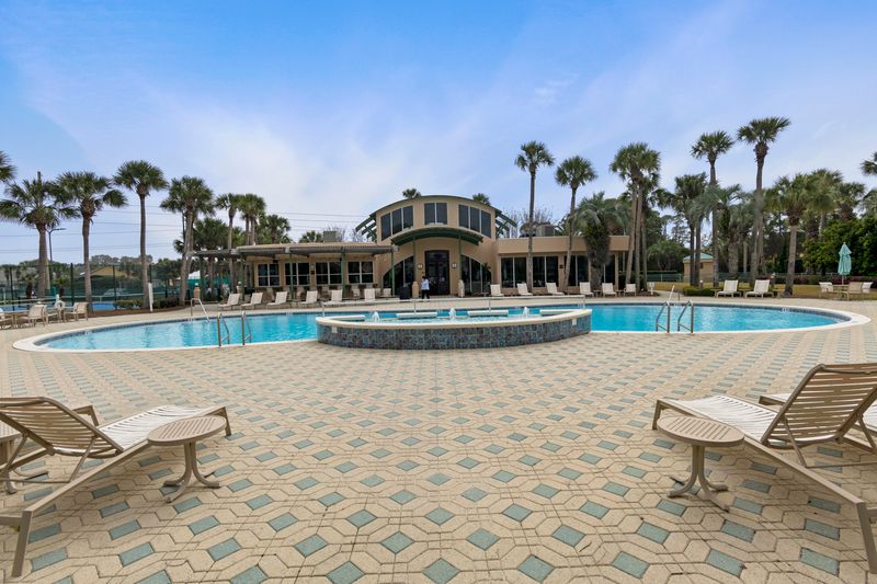 Club House Pool with loungers, tables, and plenty of seating