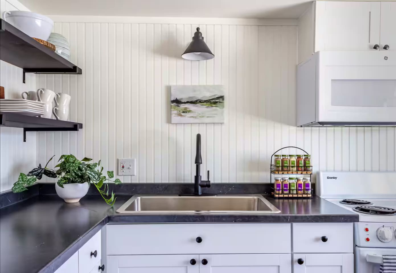 Natural light, greenery, and thoughtful touches make even dishwashing feel a little less like a chore.