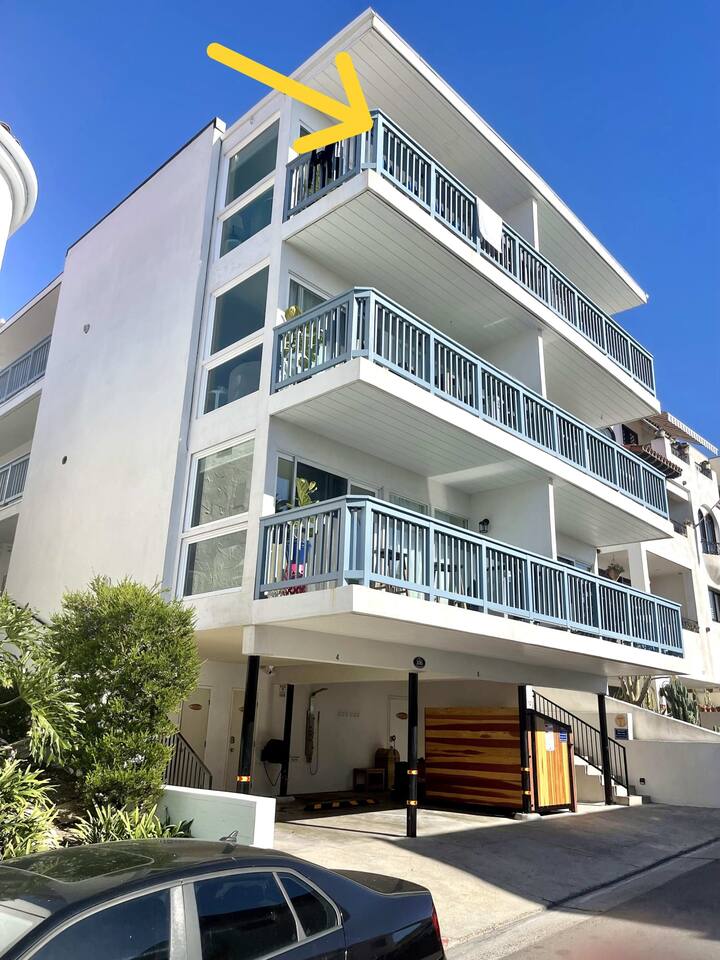 Here is a picture of the exterior of the building. We have added extreme soundproofing so that each suite feels like its own independent villa. Yet, you are right down in the pier bowl steps from the sand.  This condo is the top left balcony