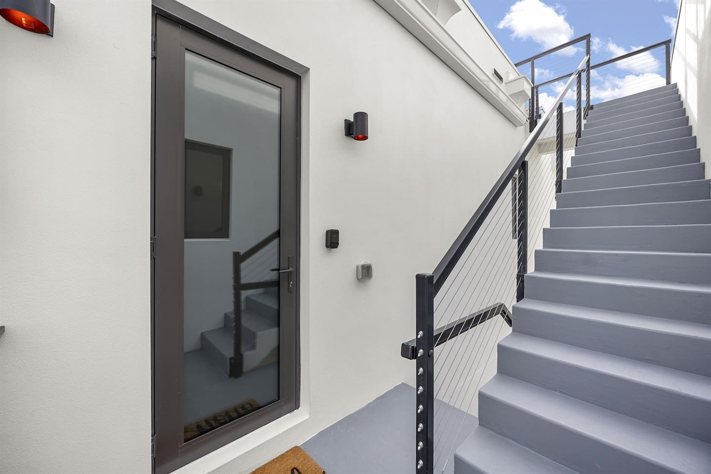 Ascend the staircase to the rooftop, where a door leads back to the indoors, offering the perfect blend of outdoor relaxation and easy access to the comfort of the interior