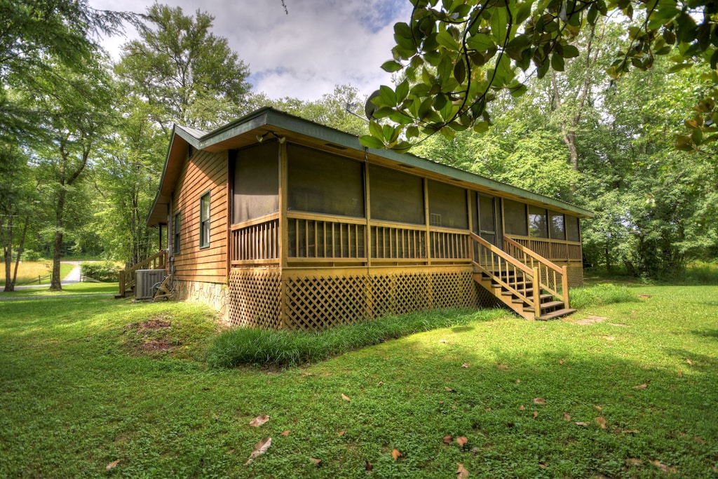 screened porch on the back of the house overlooking the creek