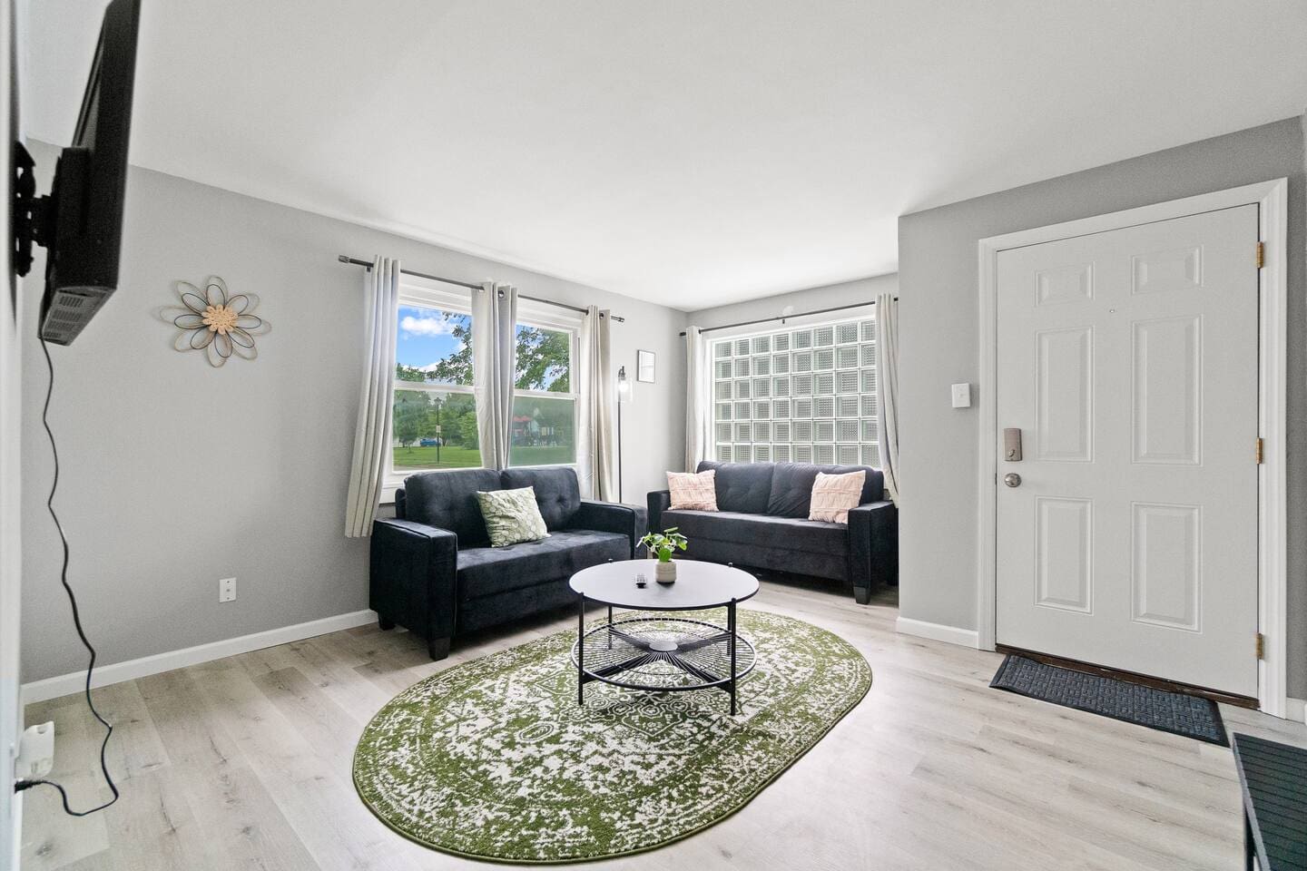 Bright and welcoming living room with a comfy couch and a stylish mini center table, perfect for relaxing.