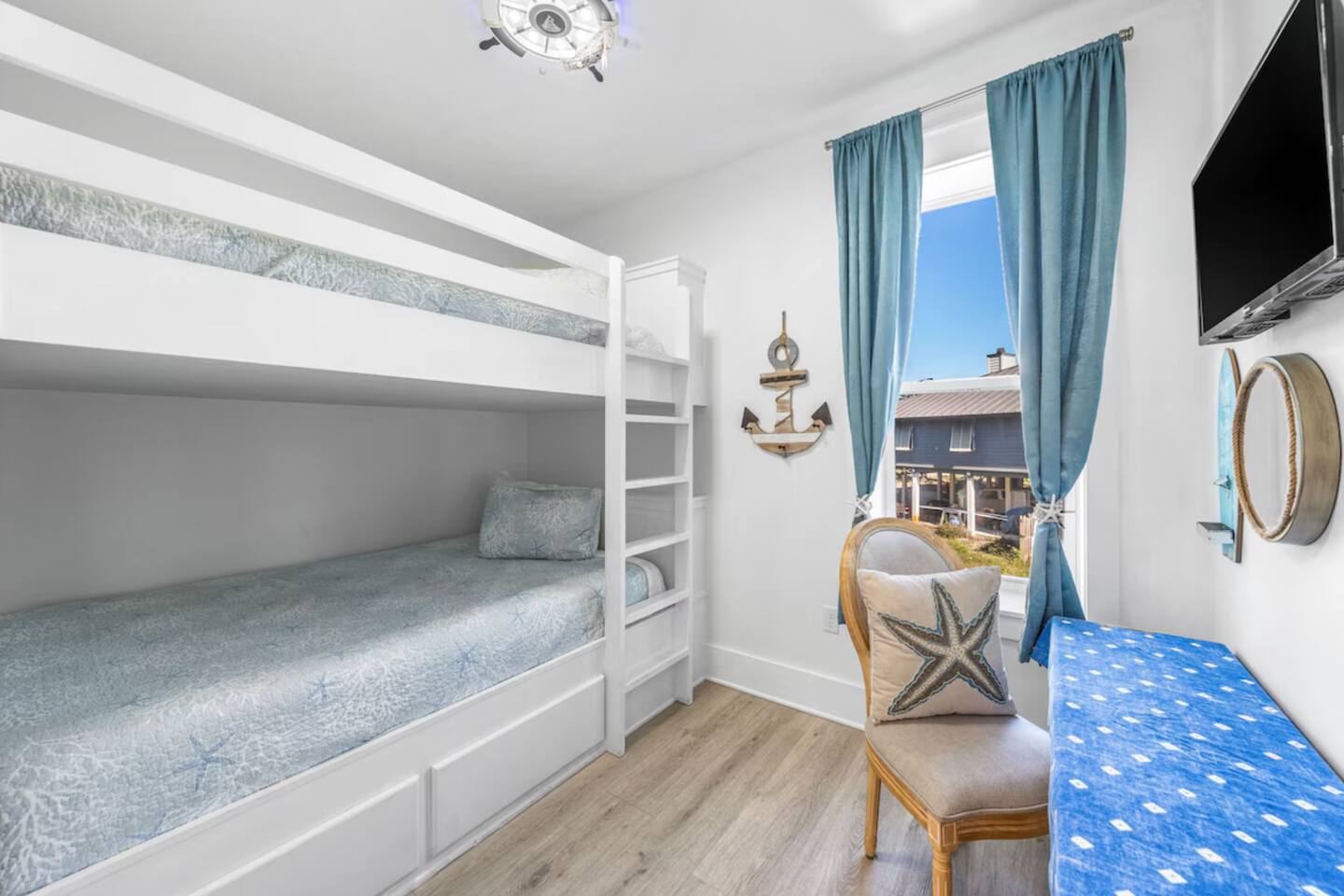Cozy Queen-over-Queen bunk room sleeps 4 comfortably. Perfect for groups/kids, this nautical-themed retreat features an smart TV and custom color-changing LED lighting. A stylish, space-saving layout designed for the ultimate beach getaway.