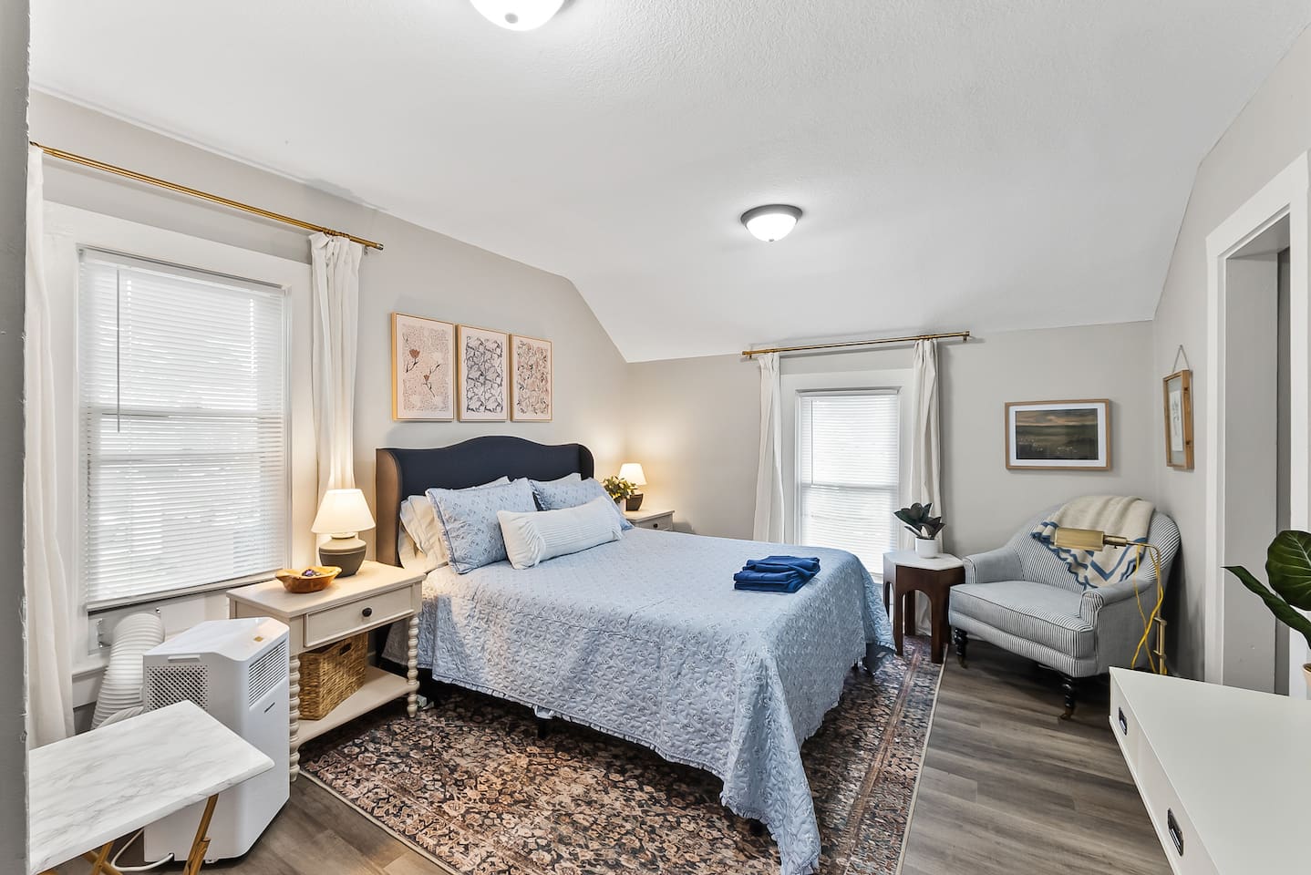 A bright, restful bedroom with a comfortable sitting nook for unwinding at the end of the day.