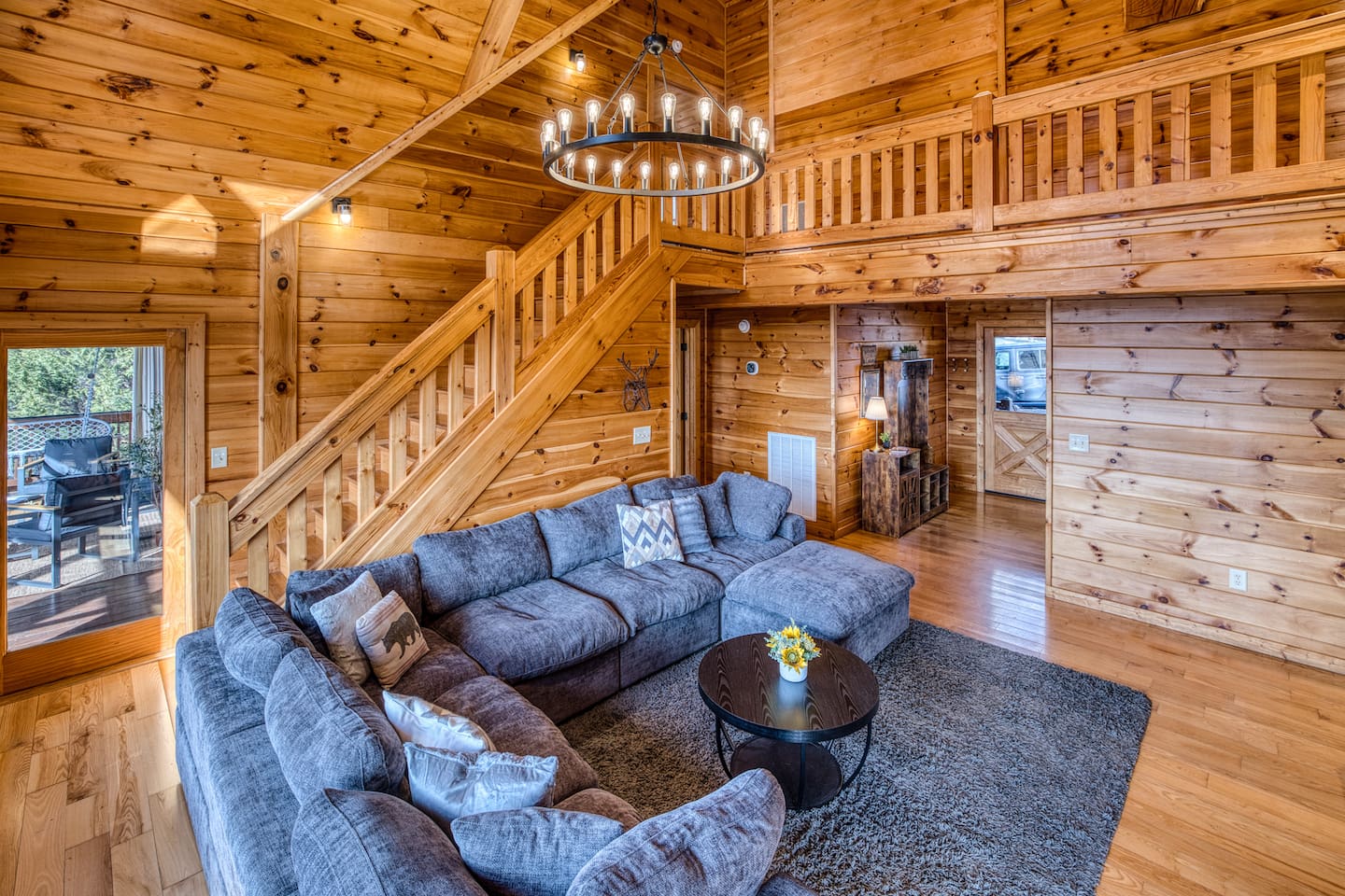 Main living room with beautiful A-frame ceiling, wall of windows, double-sided gas fireplace, and stunning mountain views! 