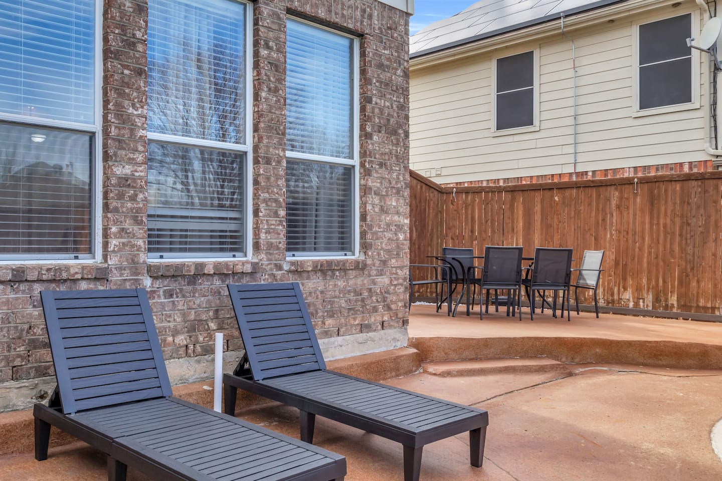 Comfortable patio loungers overlooking the private pool, perfect for sunbathing, relaxing, or enjoying a quiet moment outdoors.
