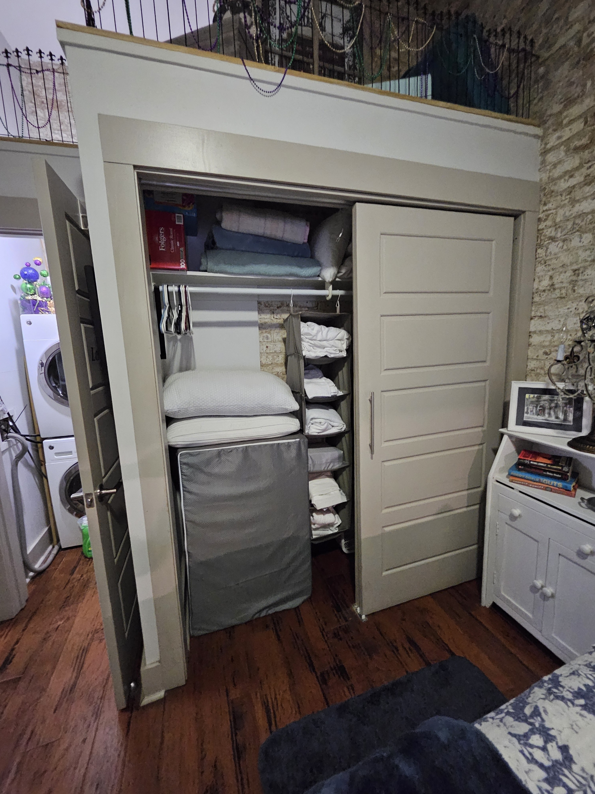 Wall closet contains extra bedding, linens and portable/folding twin cots.