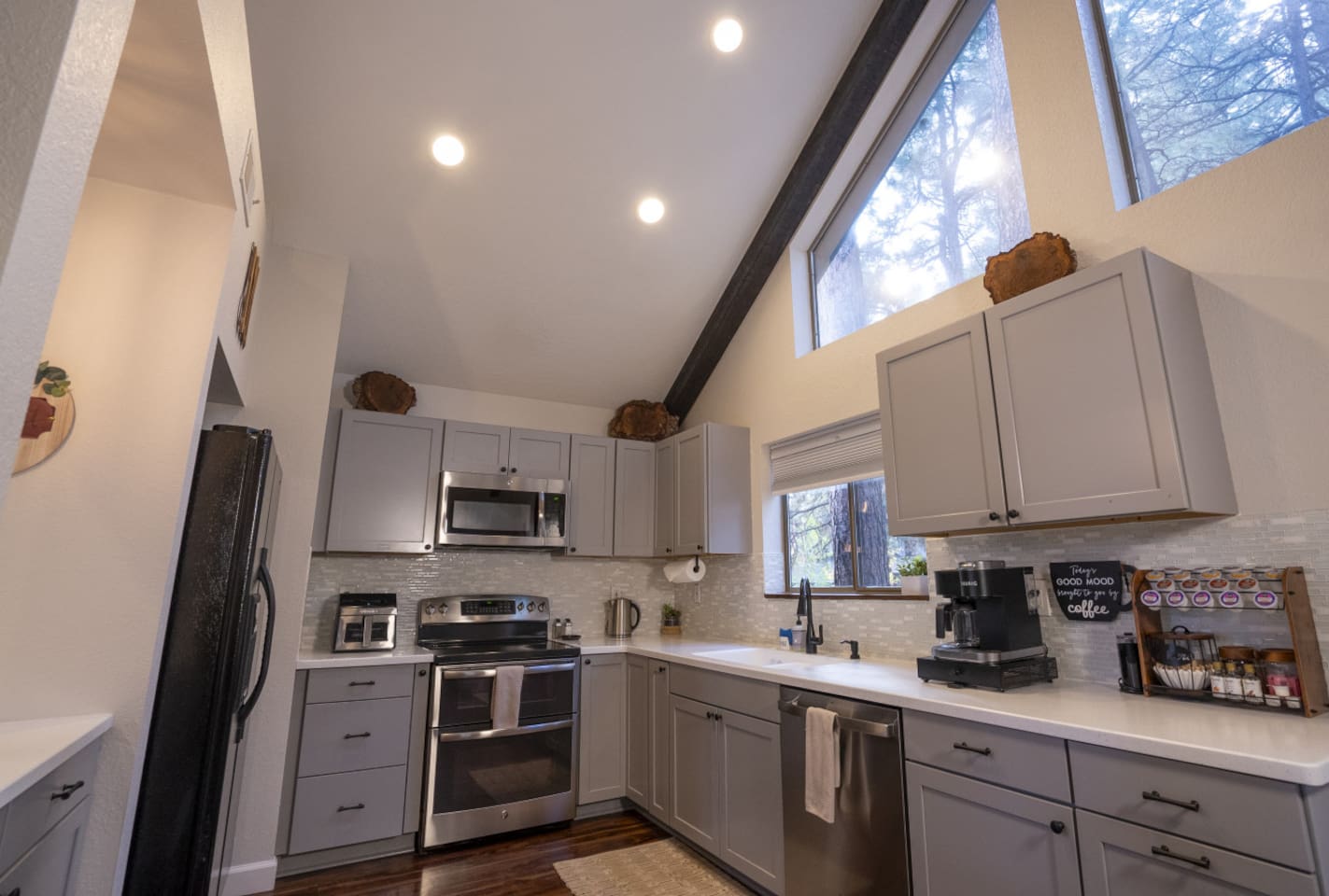 Bright kitchen with high ceilings, full-size appliances, and space for simple meals during your stay.