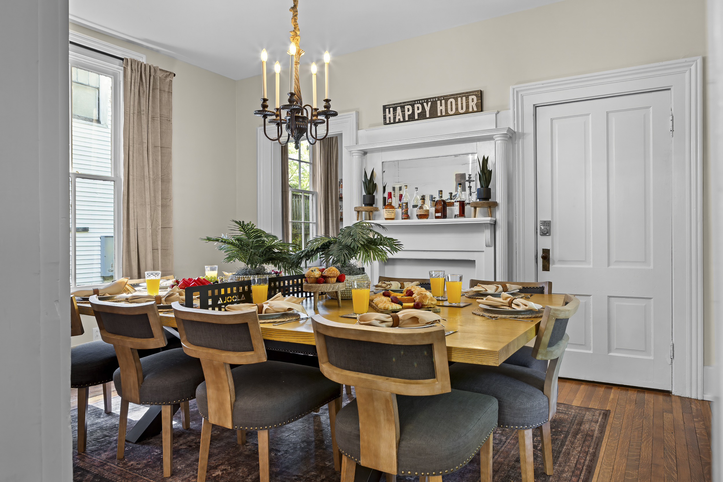Gather the whole group around the long dining table, where the “Happy Hour” sign above the fireplace sets the perfect tone for shared meals and conversation.