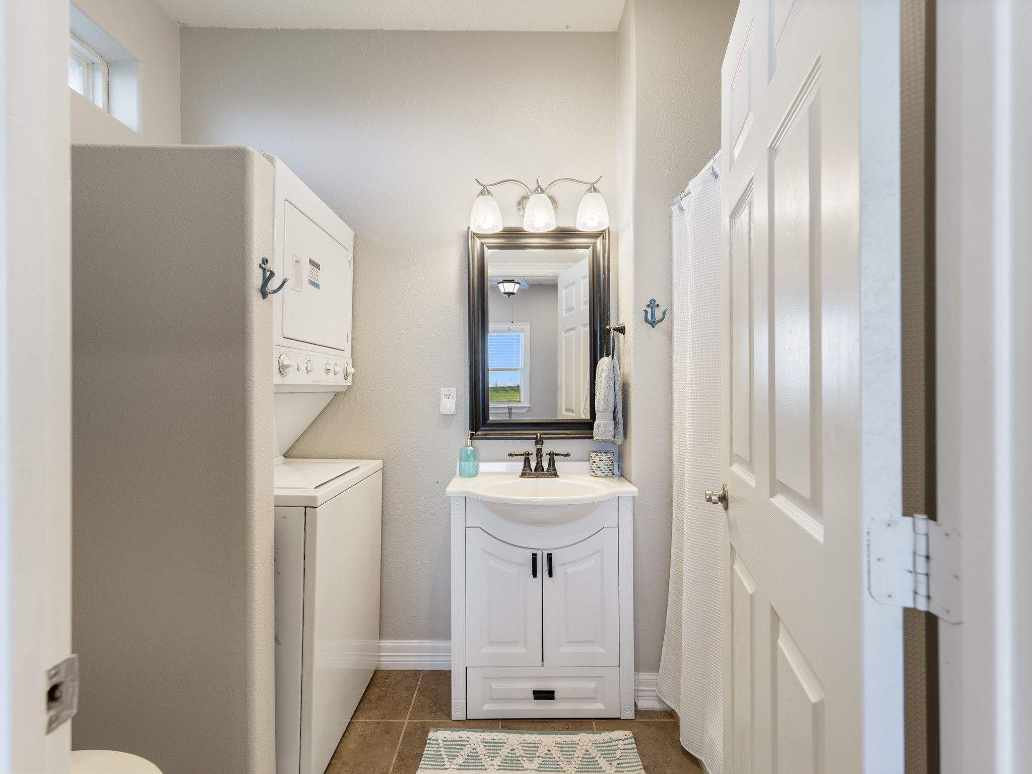 Primary bathroom with washer and dryer.