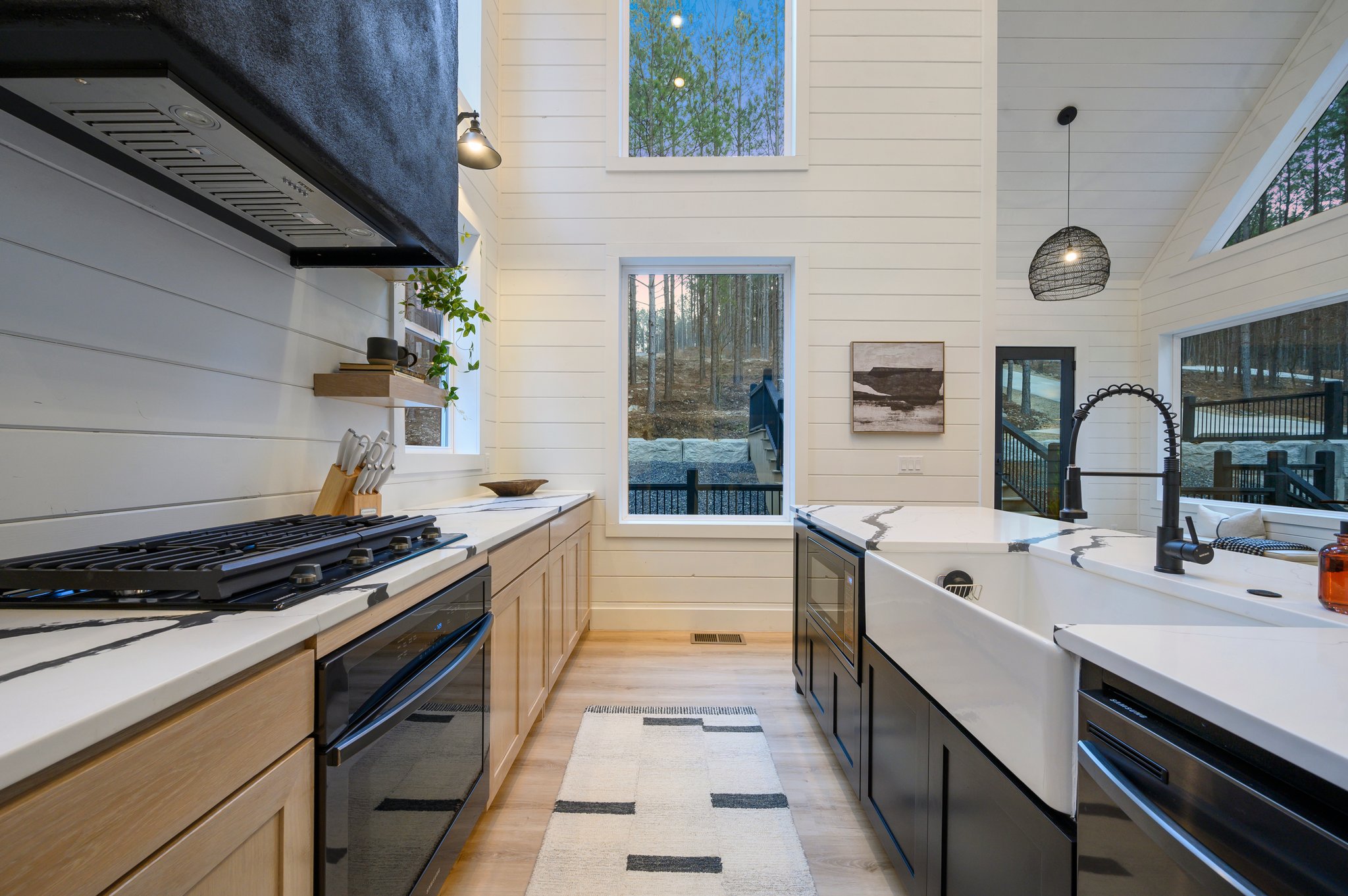 The oversized farmhouse sink and high-end appliances make cooking both stylish and effortless.