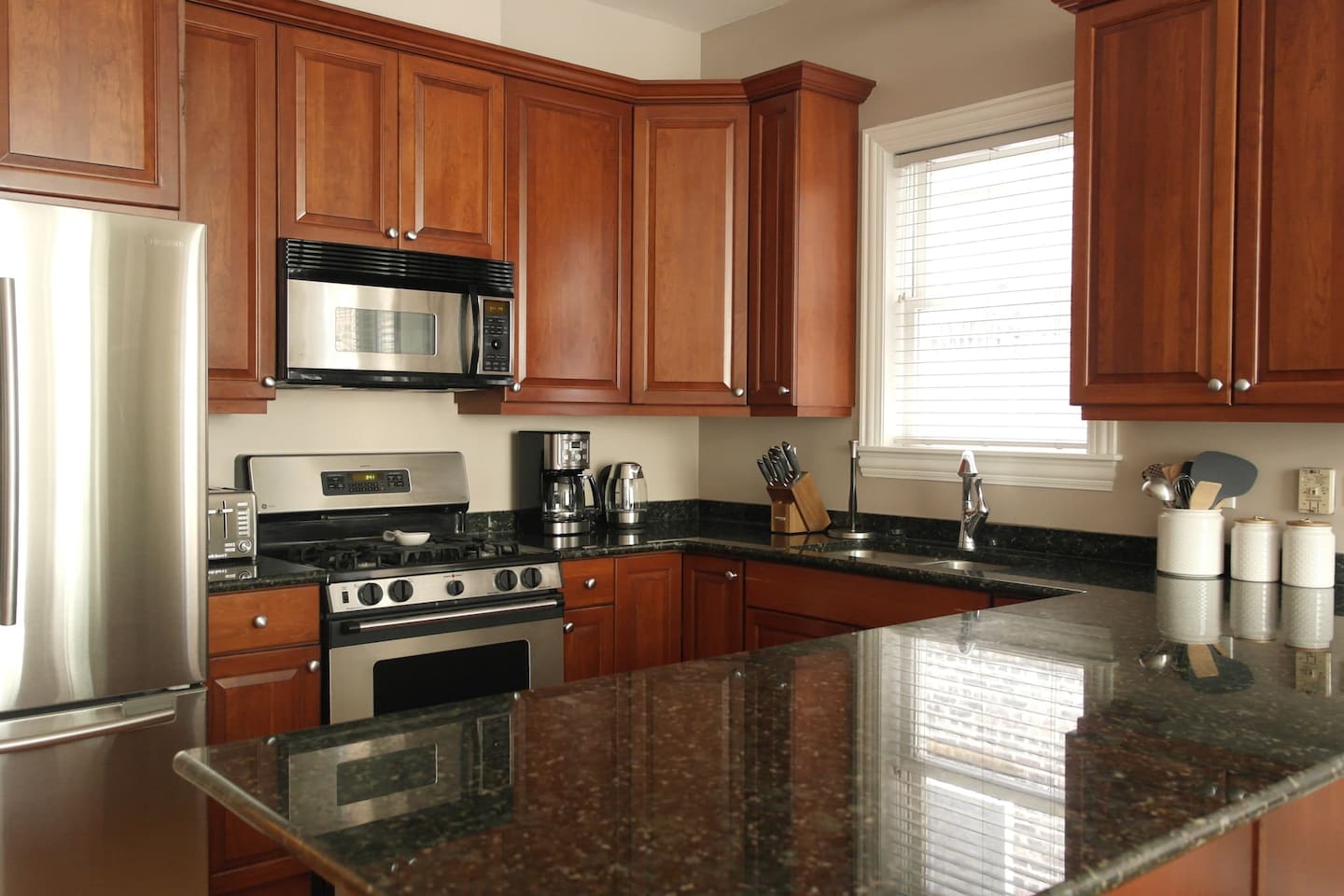 Kitchen fully stocked with cookware, dishes, and essentials