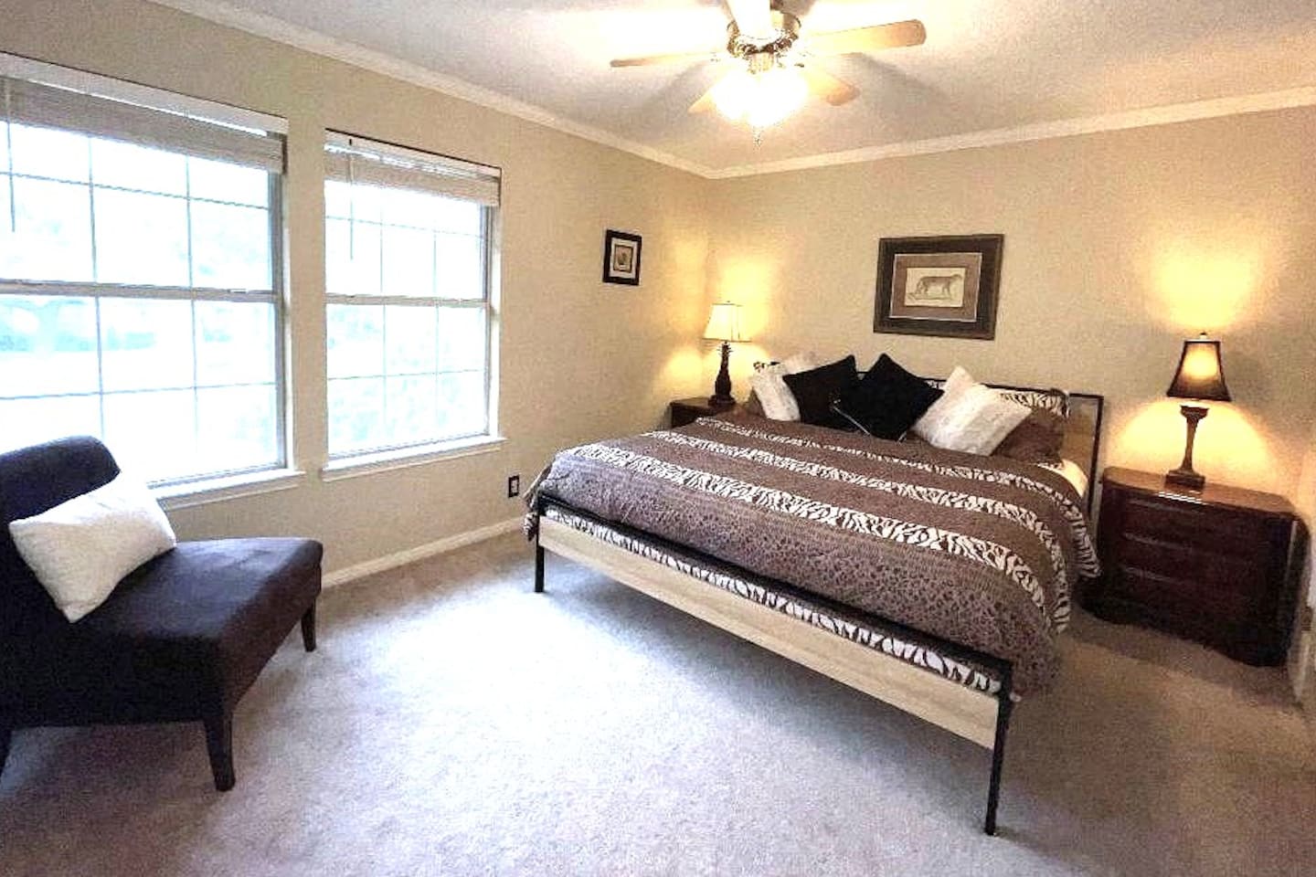 One of five private bedrooms and one of two king beds in the home, the 'Safari Suite' features memory foam toppers, treetop views, a walk-in closet, and bedside charging stations.