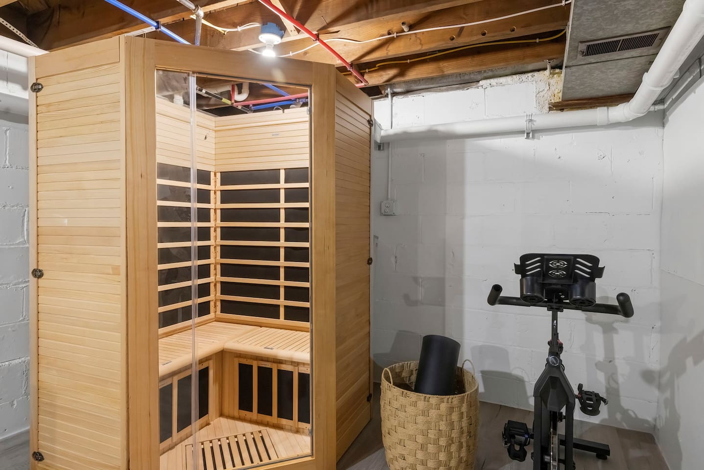 Sauna and stationary bike with a yoga mat. 