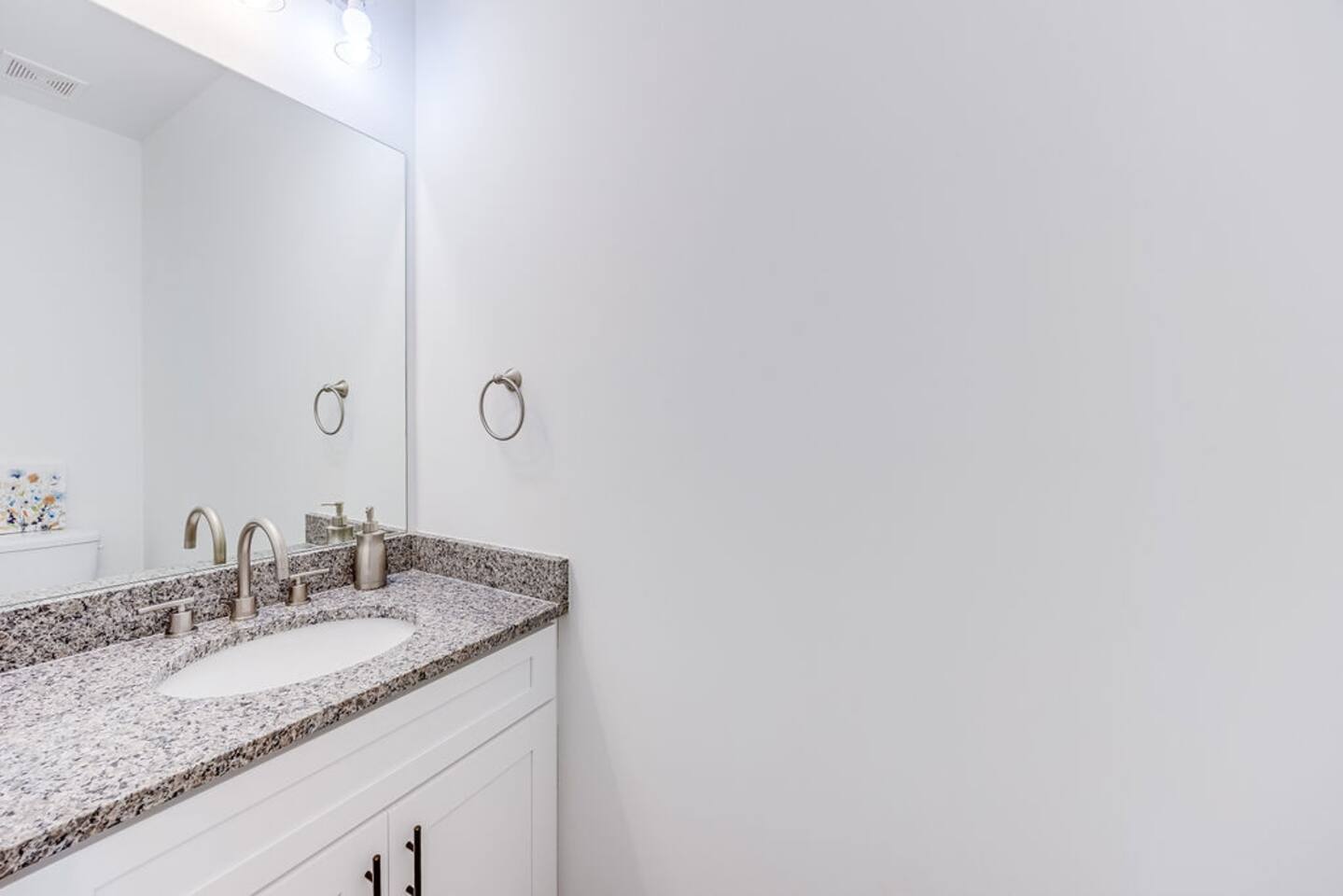 Convenient half bathroom, perfect for quick use with modern fixtures and a clean, simple design.