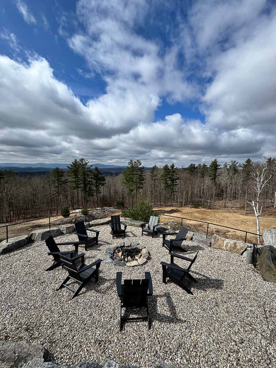 Stone fire pit overlooking the valley at Sunset Falls Estate