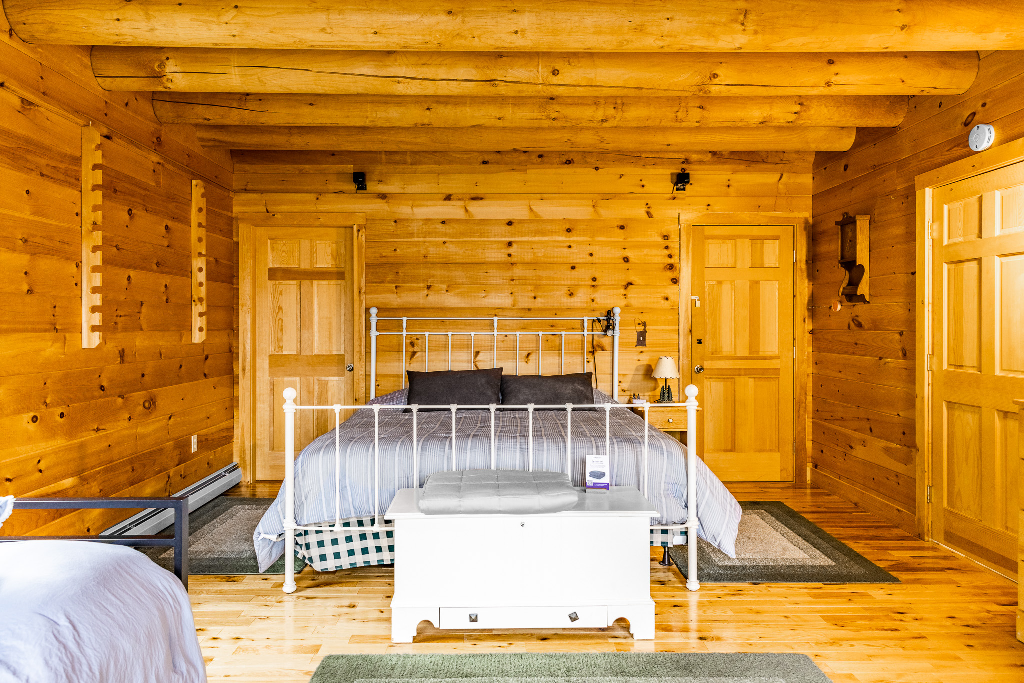 The main floor master ensuite, with a comfortable king size bed, 2 twin beds, TV for streaming your favorite shows, and a private bathroom. Plus deck access with hammock outside overlooking the lake!