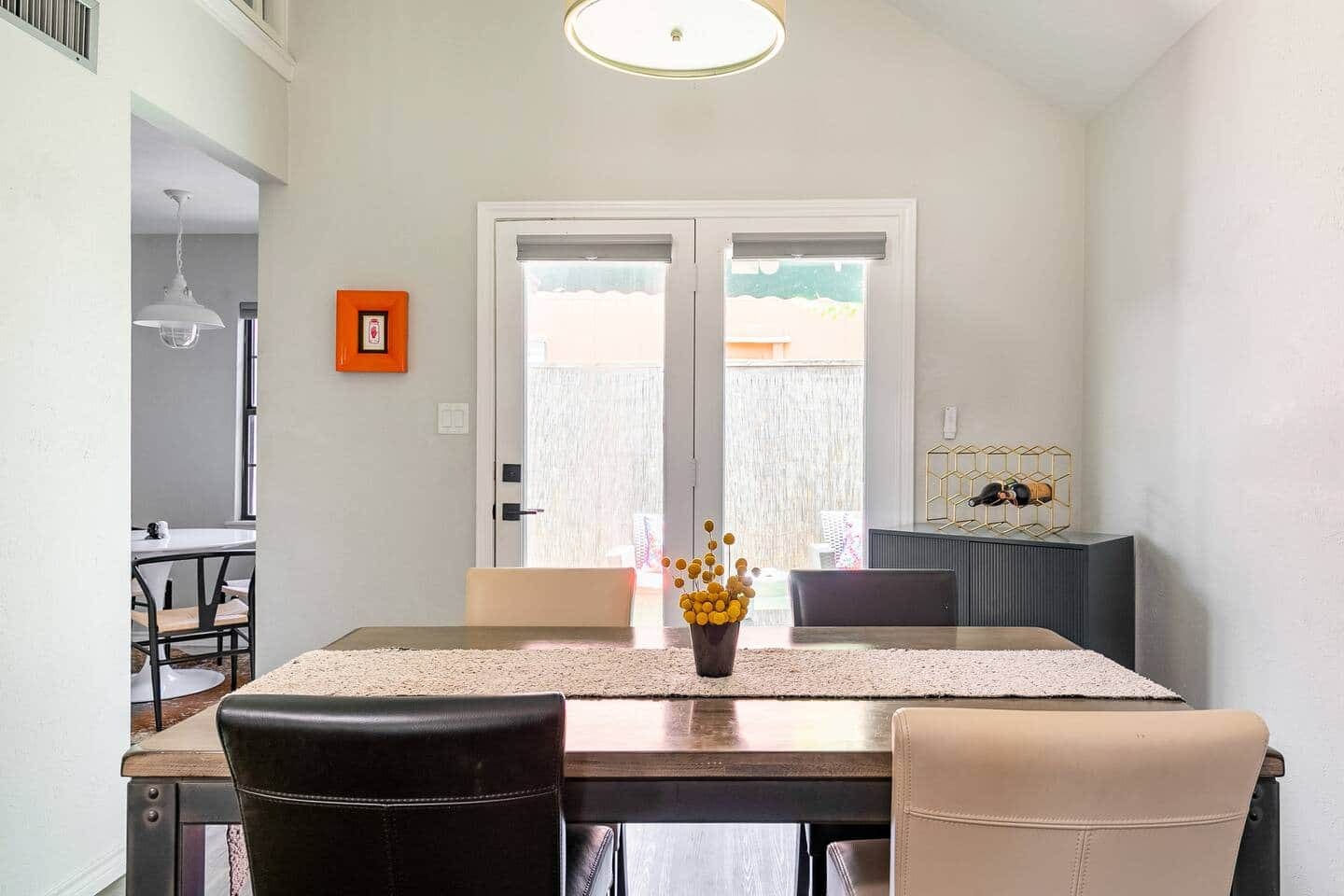 Dining table with seating for four, accented by modern chairs.