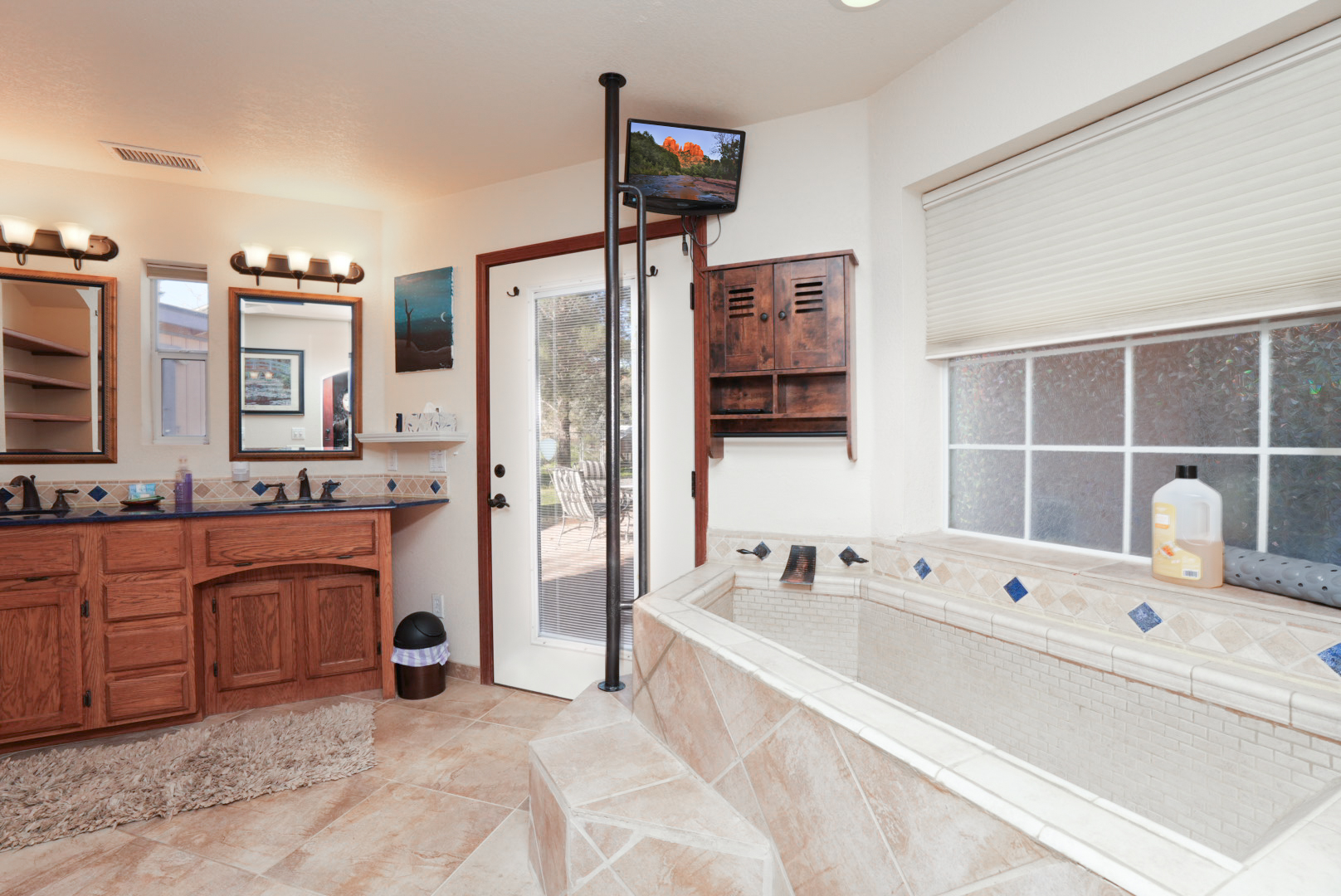 Spa-inspired ensuite with dual vanities, an oversized soaking tub with TV, and thoughtful details that make winding down effortless.